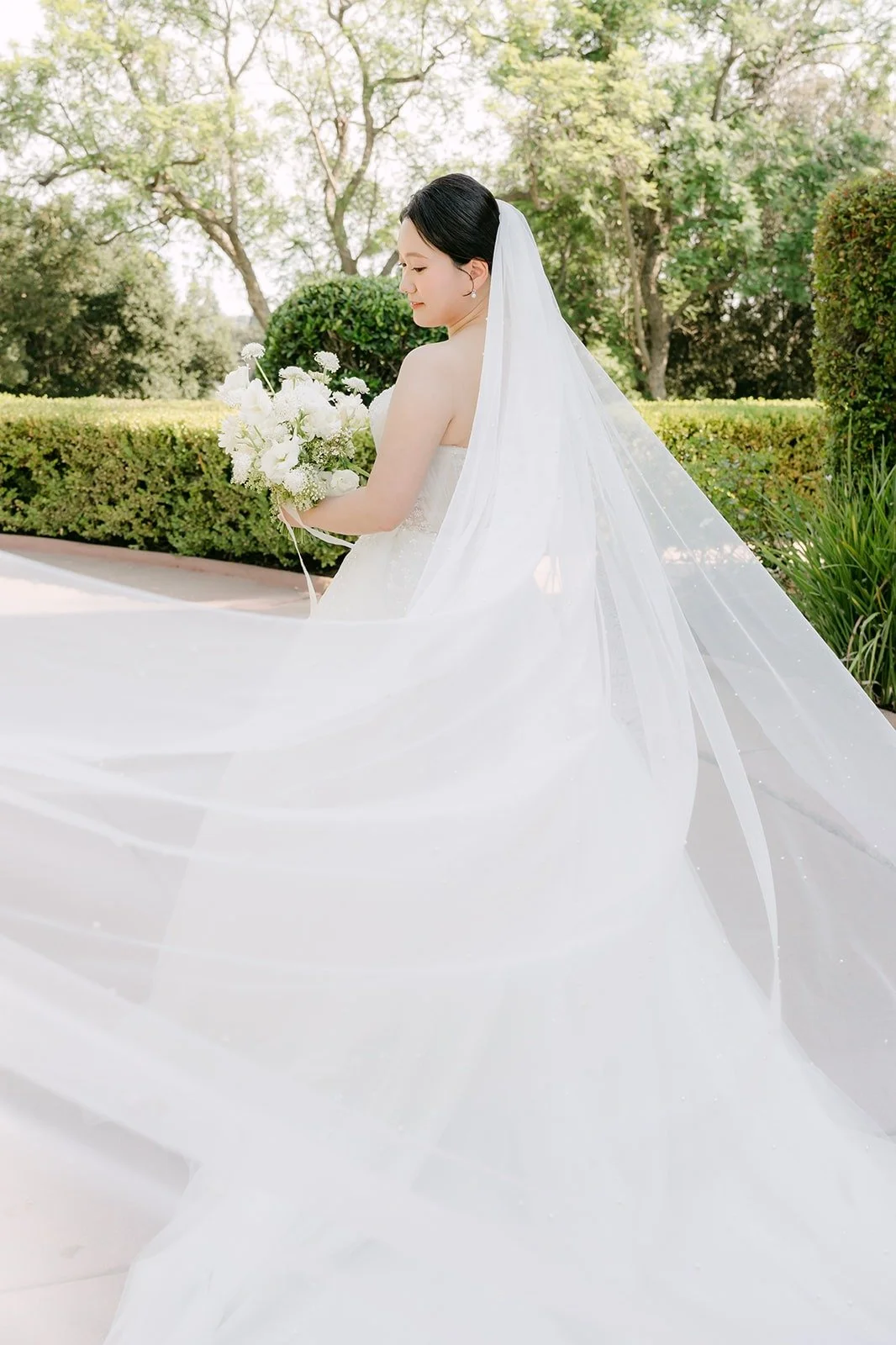 Amy's cathedral veil sweeping across the courtyard
