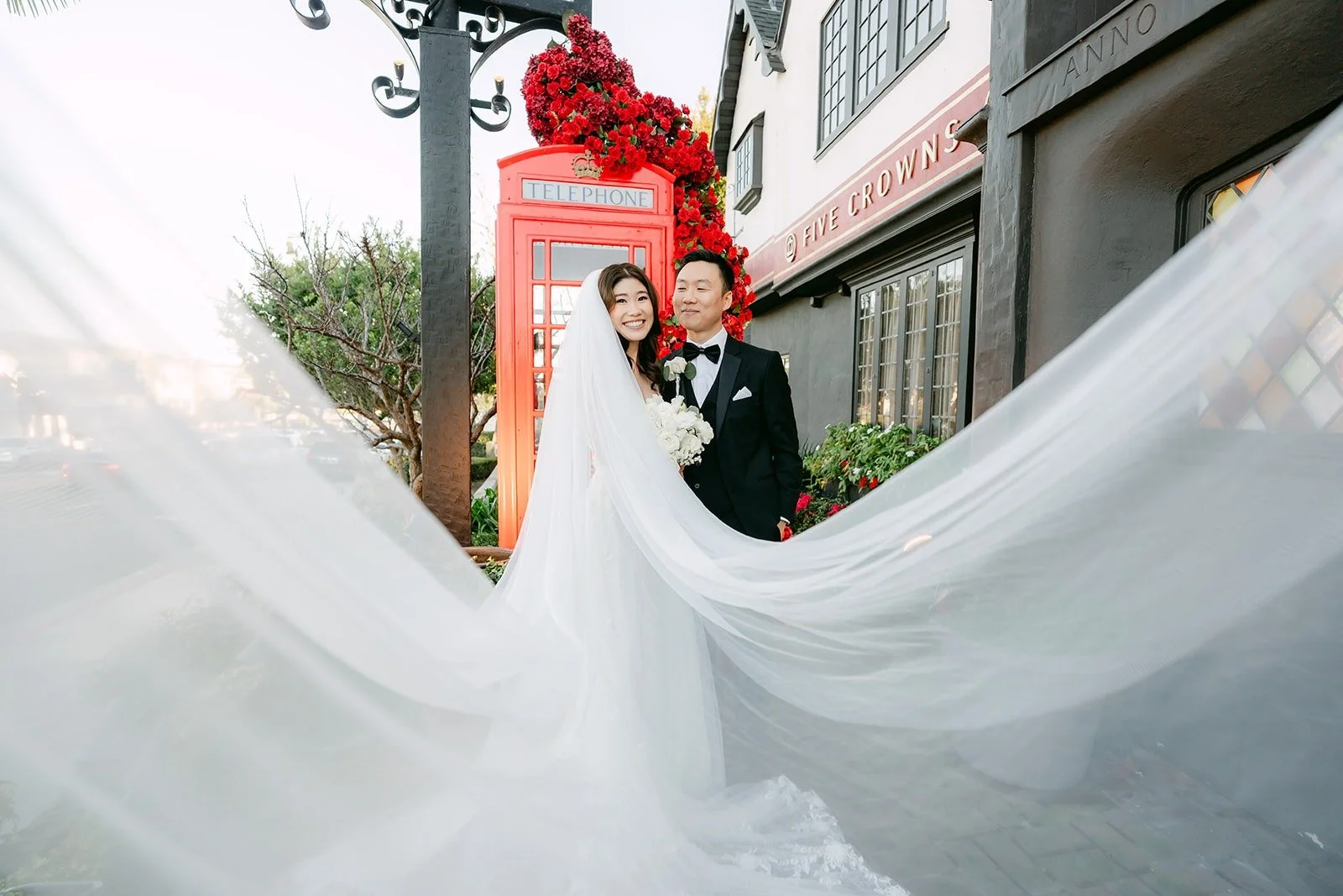 Valerie's veil billowing across the brick path in front of the red phone booth