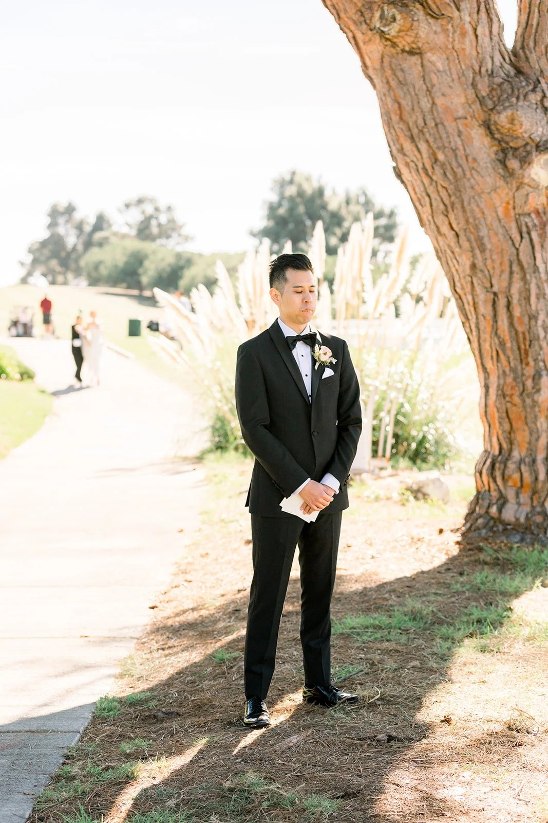 David waiting beneath a tall pine at Los Verdes Golf Course