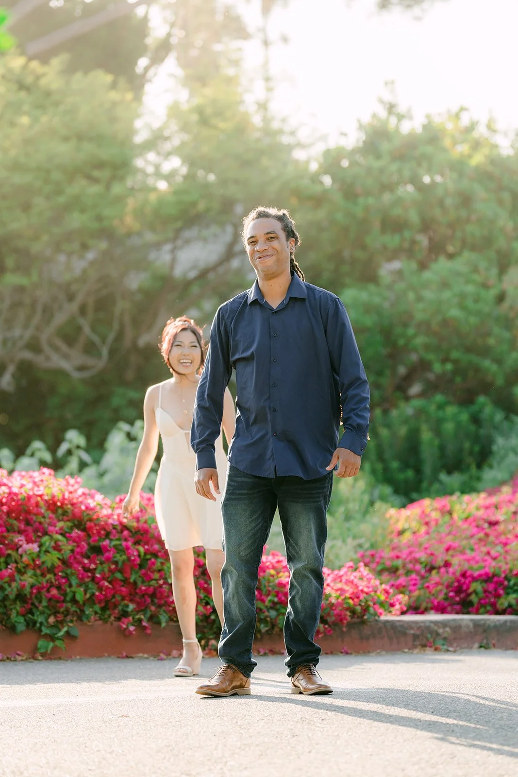 Michael walking ahead holding Amy's hand on the garden path.