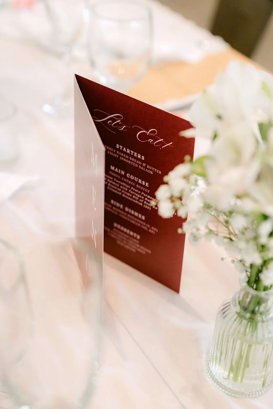 Burgundy menu tucked into a white napkin