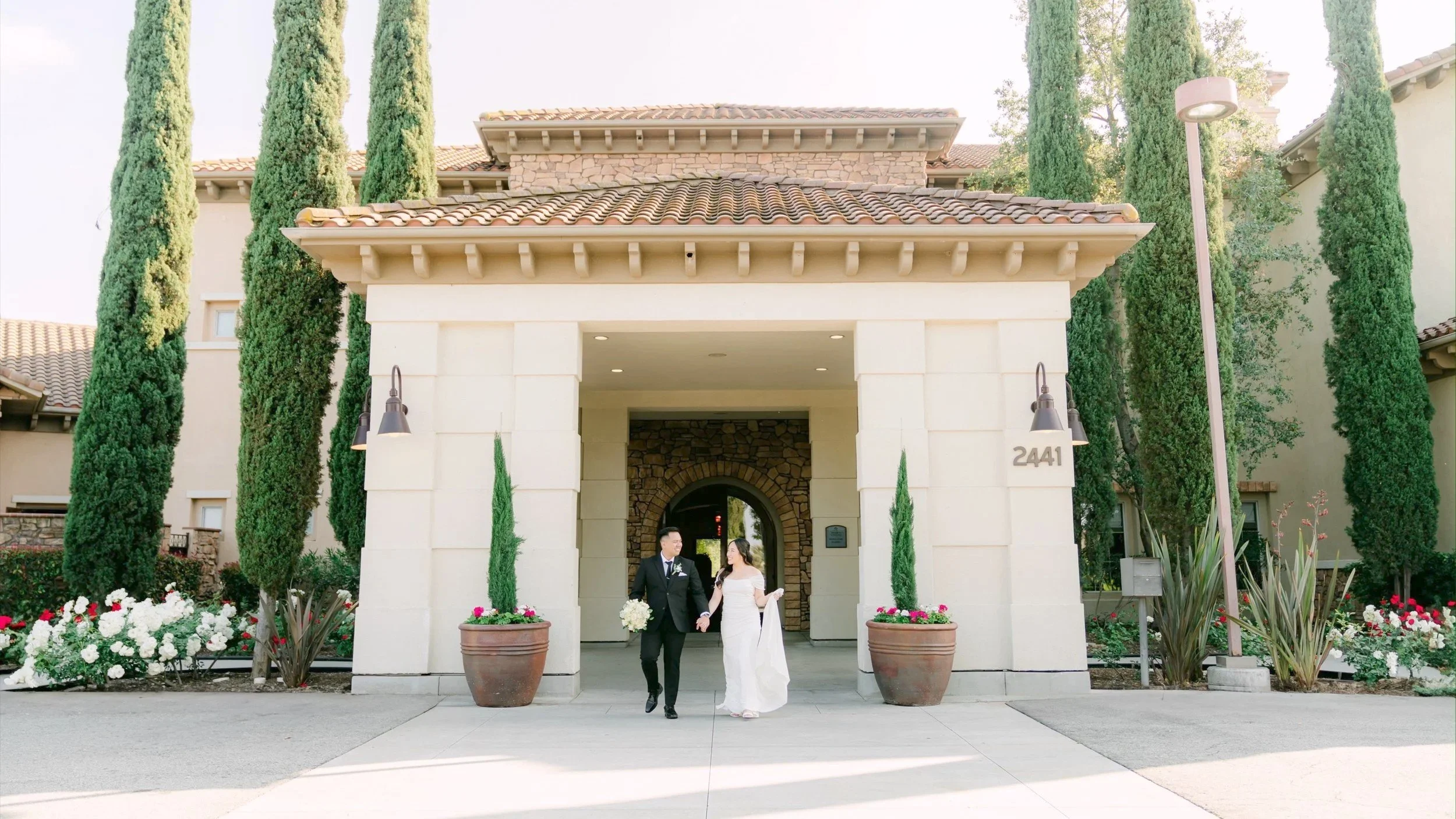 Isabel and Vijed at the front entrance of Vellano Estate