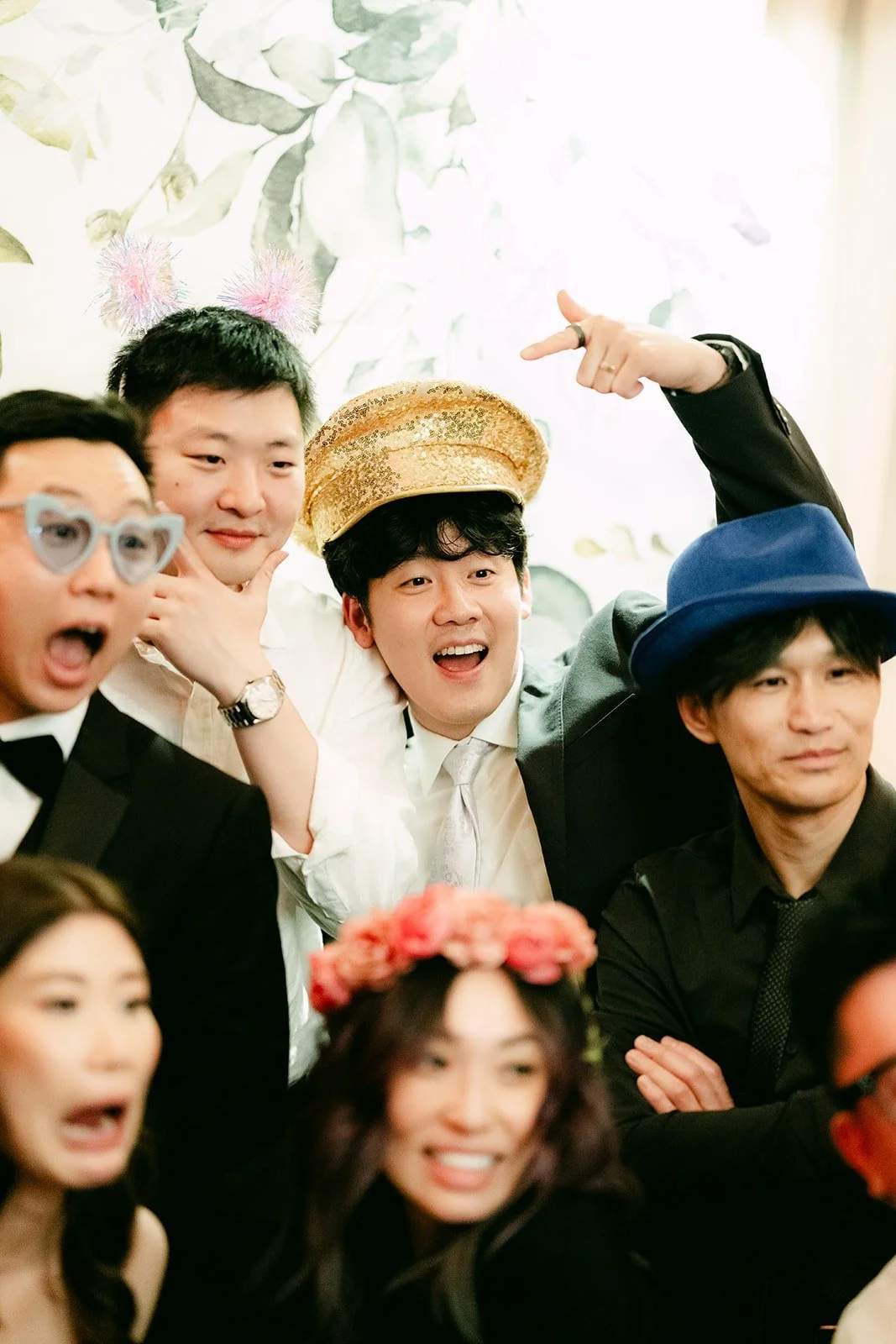 Guests in props and hats at the photo booth