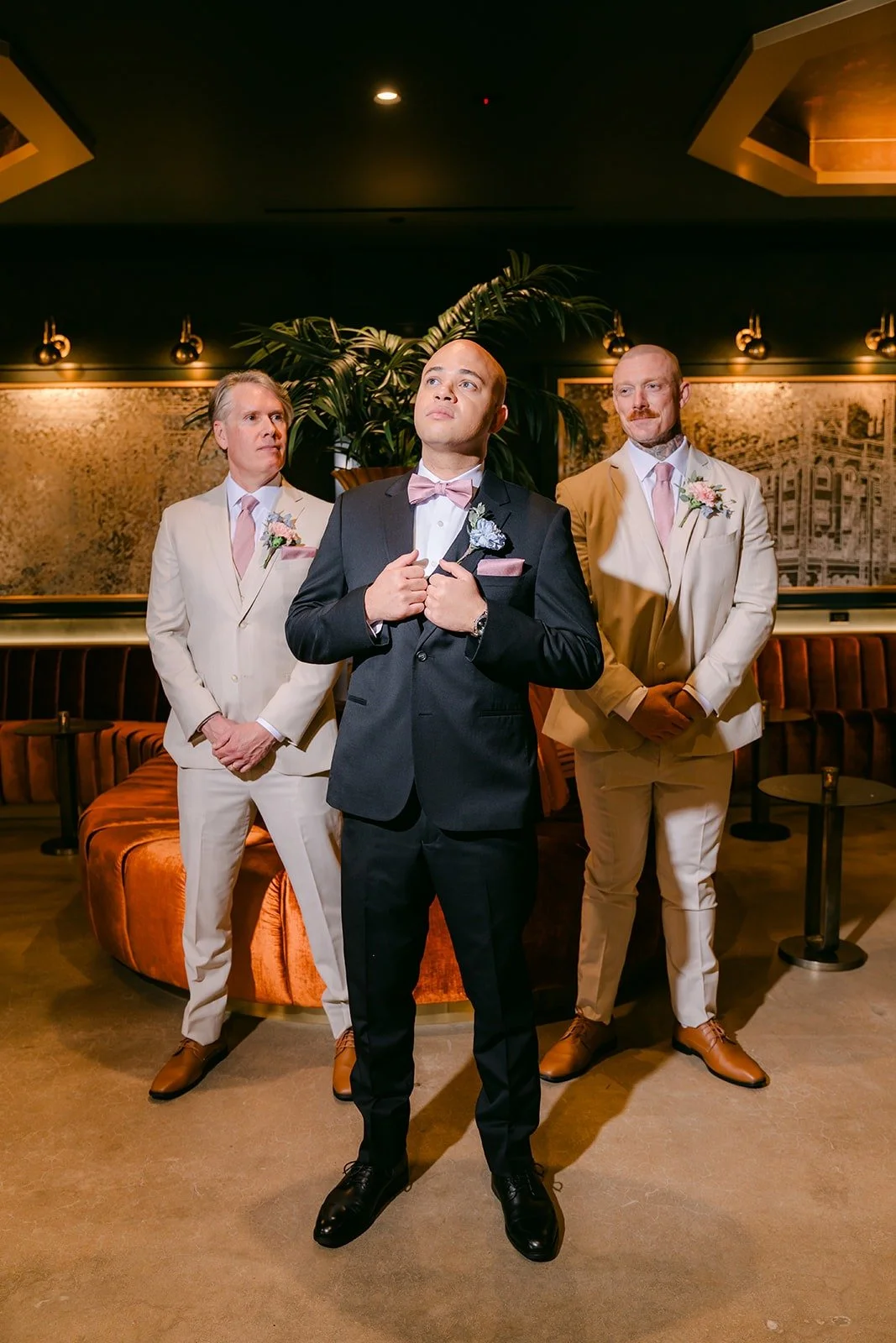 Brandon and his groomsmen in suits in the lounge at The Headquarters