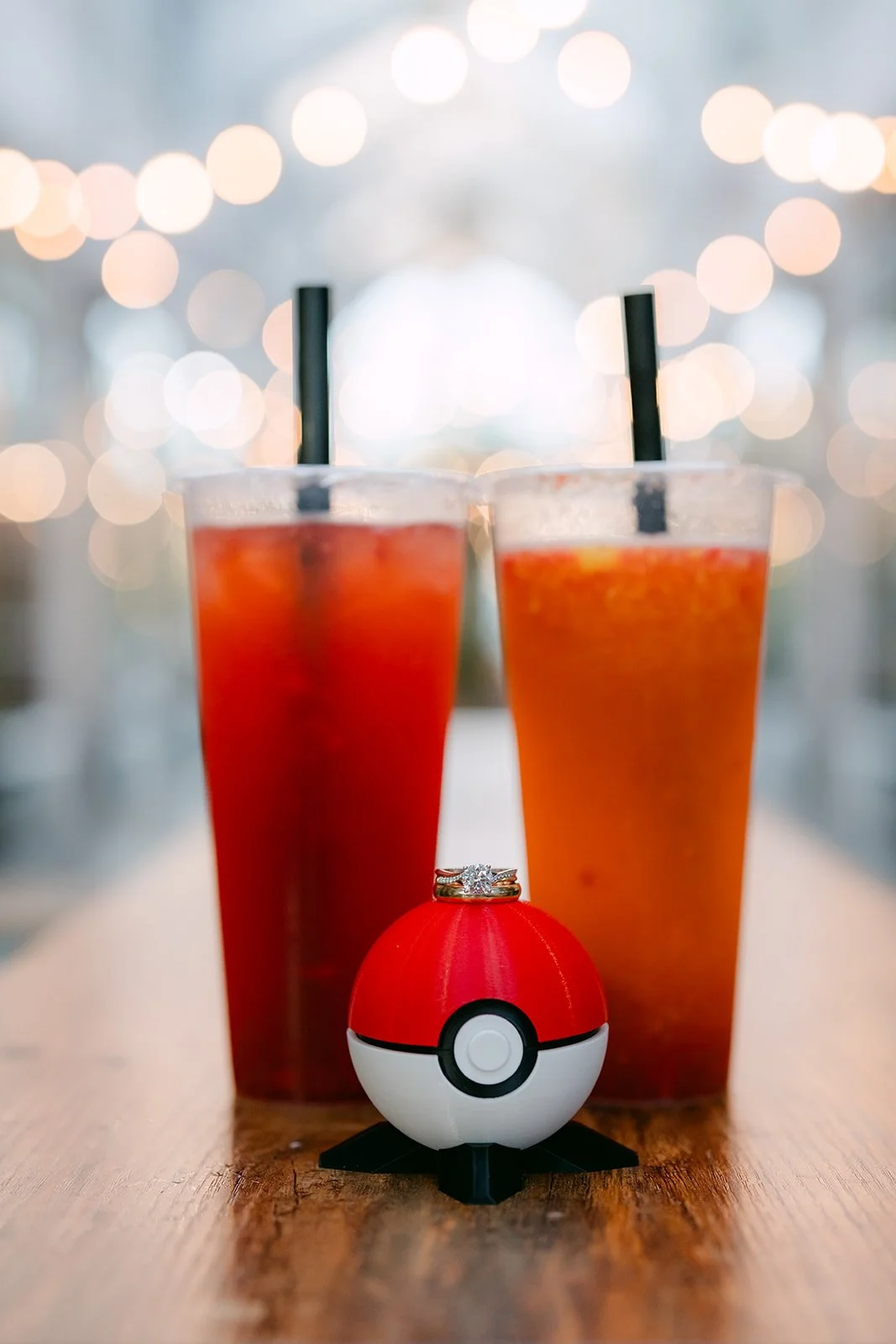 Two drinks and a Poké Ball on a café table inside the Burlington Arcade.