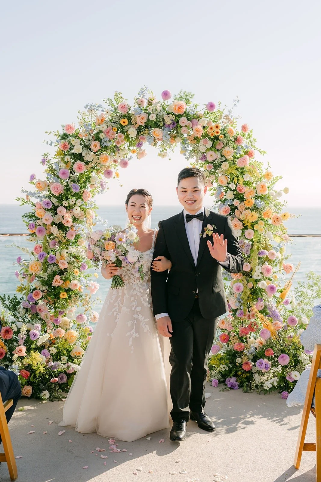 Kylie and Mario facing their guests as newlyweds