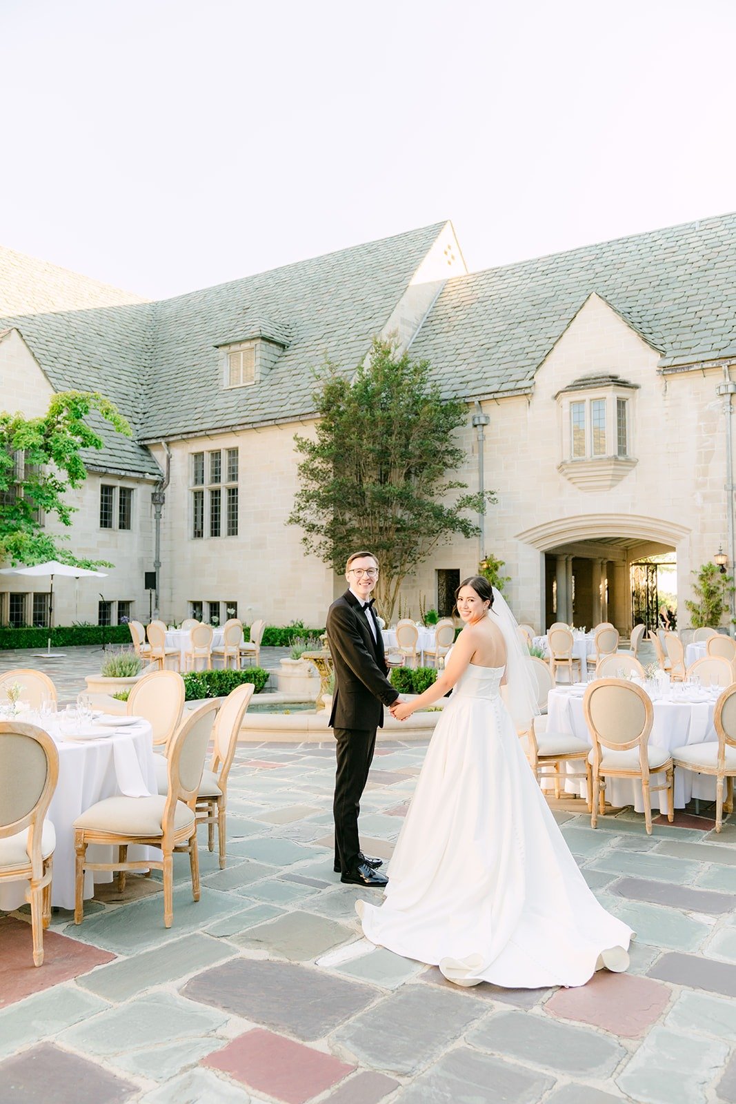 Brianna and Nik in the courtyard with the mansion behind them