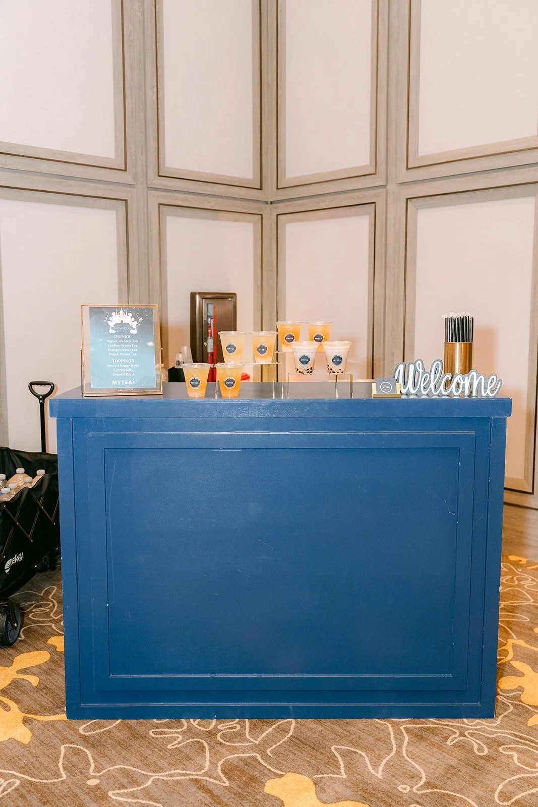The navy blue boba bar set up in the ballroom foyer