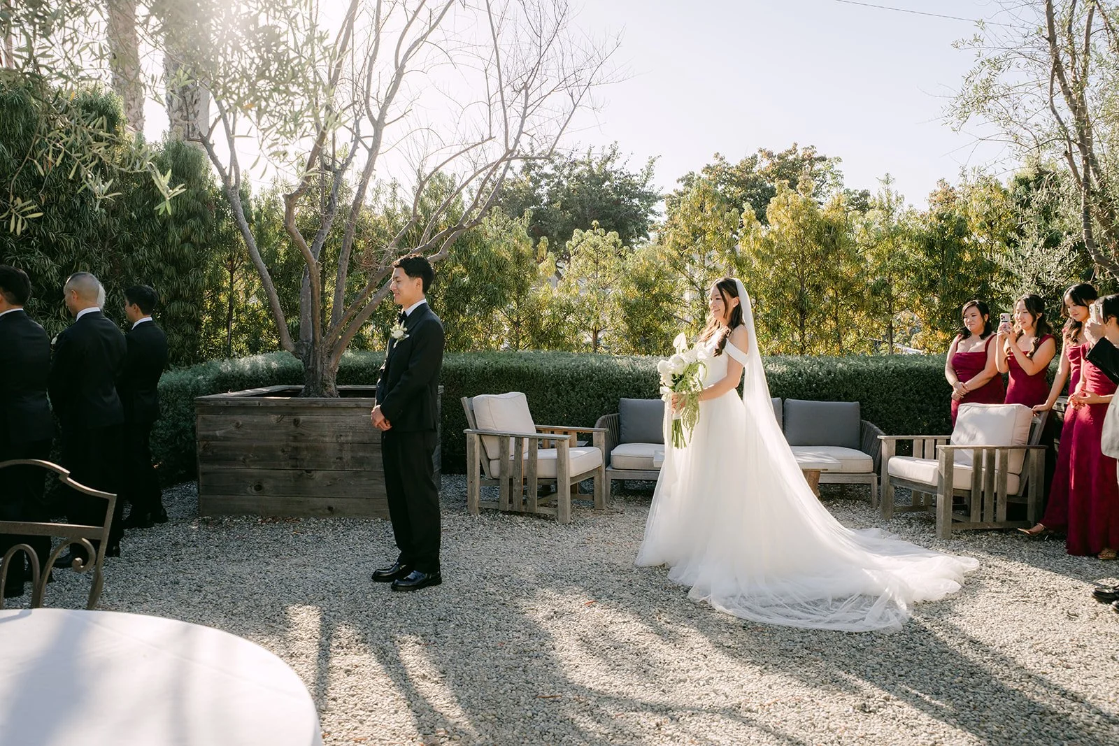 Jadee walking up behind Richard among the olive trees