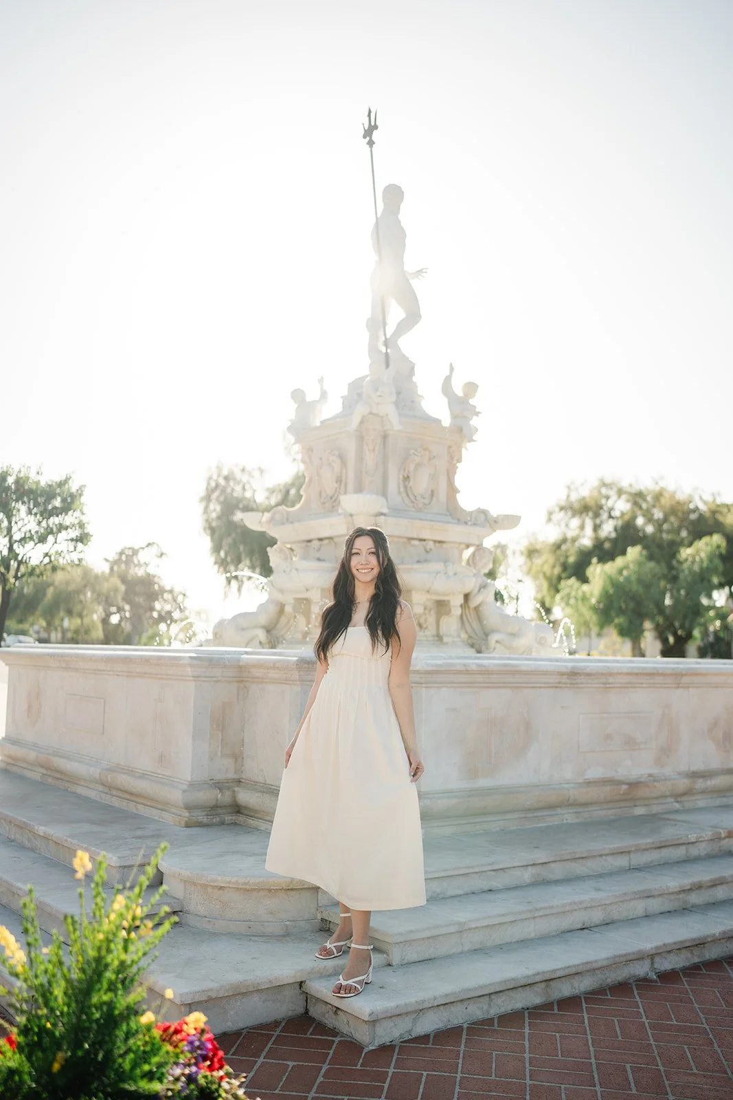 Victoria walks along the fountain's stone steps.