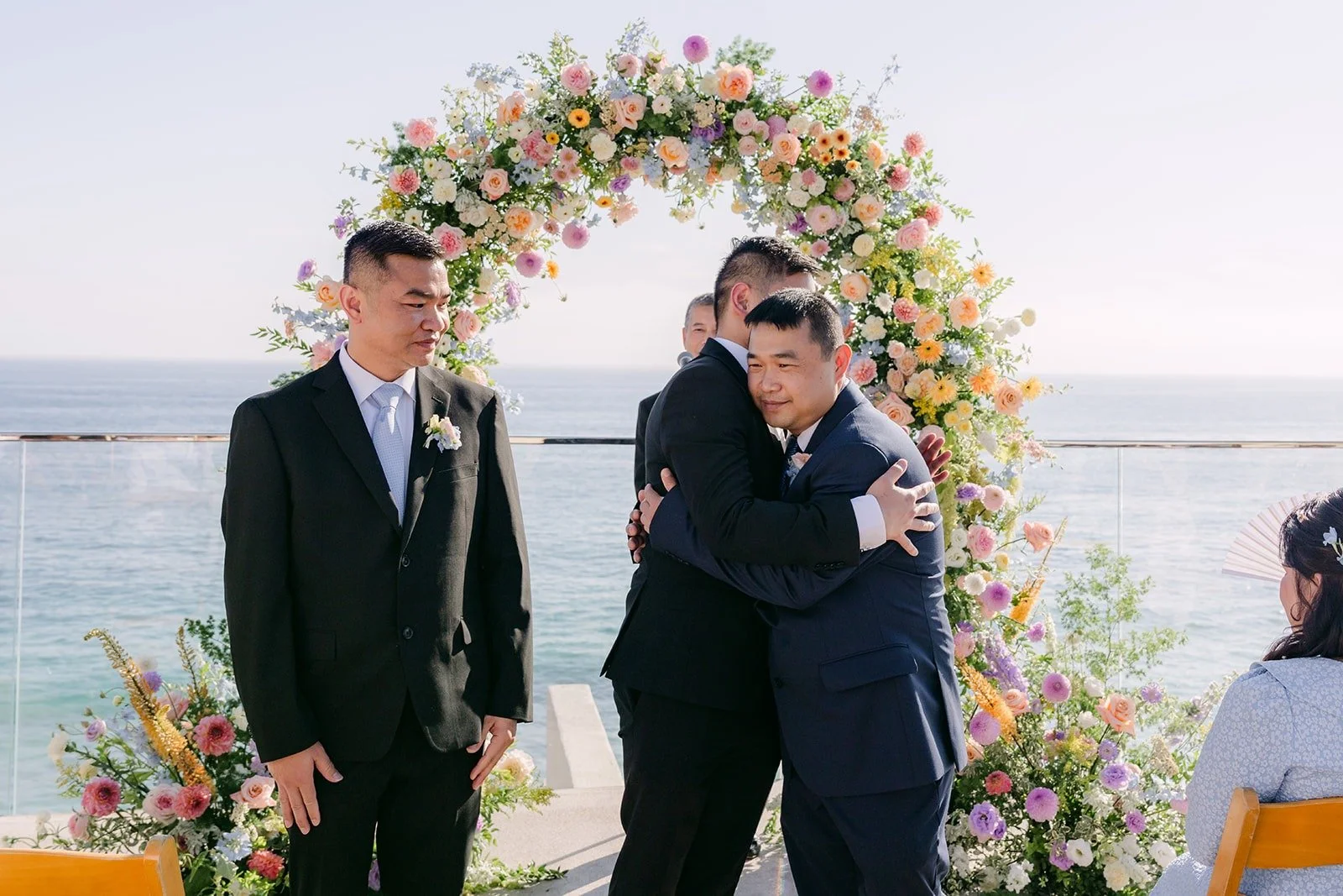 Mario hugging a guest at the front of the aisle