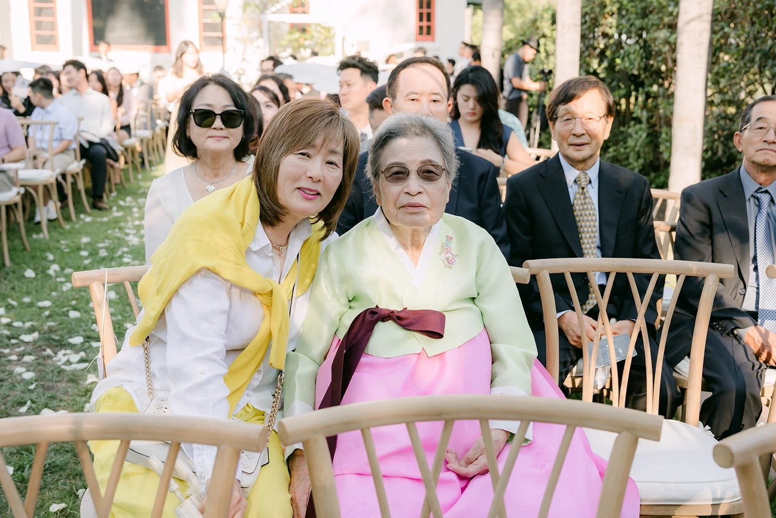 Family members in hanbok smiling at the reception
