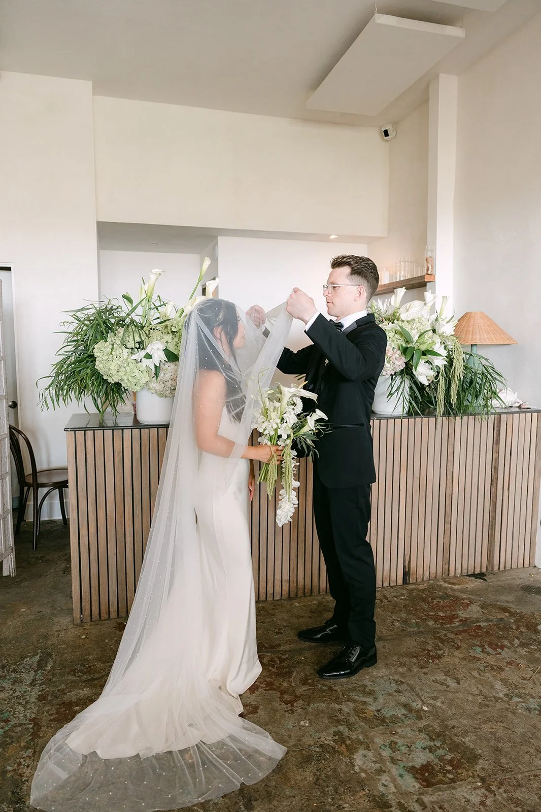 Matthew lifting Justine's veil