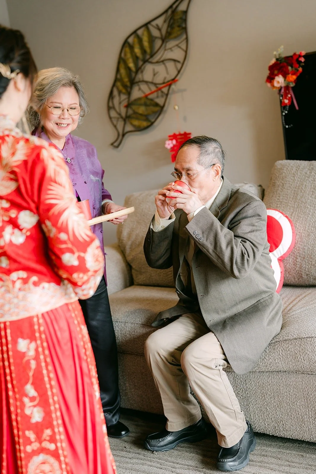 A family member sips tea during the tea ceremony at the DoubleTree Claremont, photographed by One and Only Production