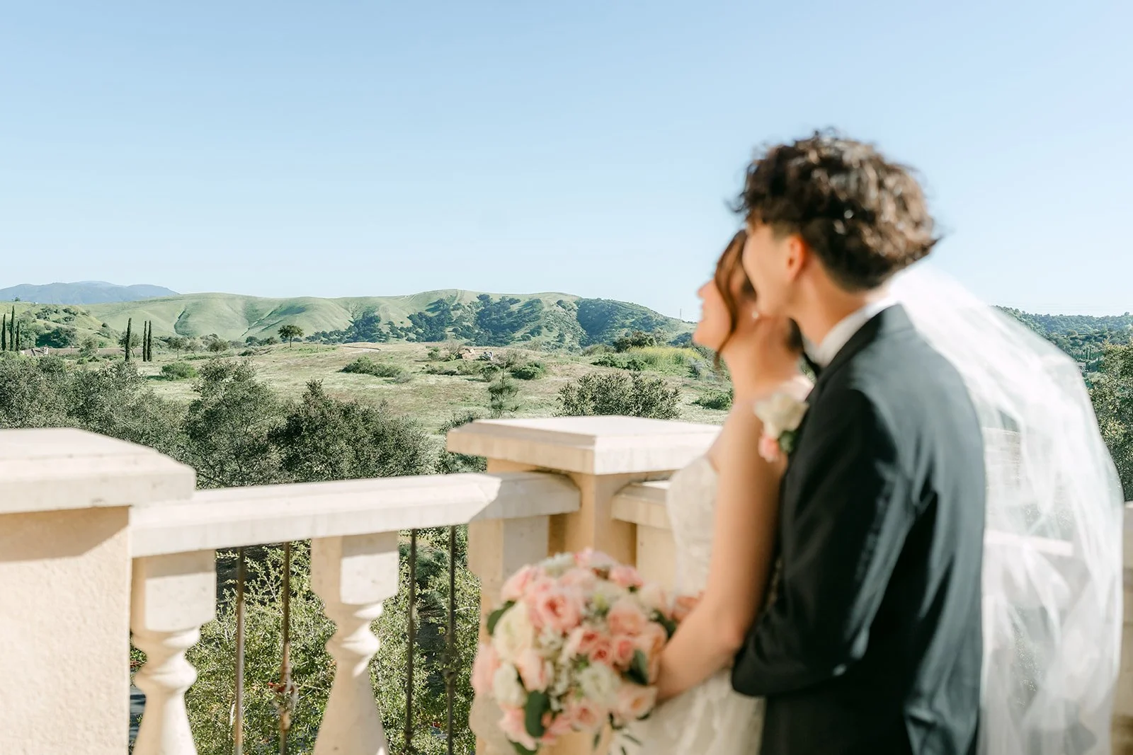 Victoria and Tony on the balcony with rolling hills behind them
