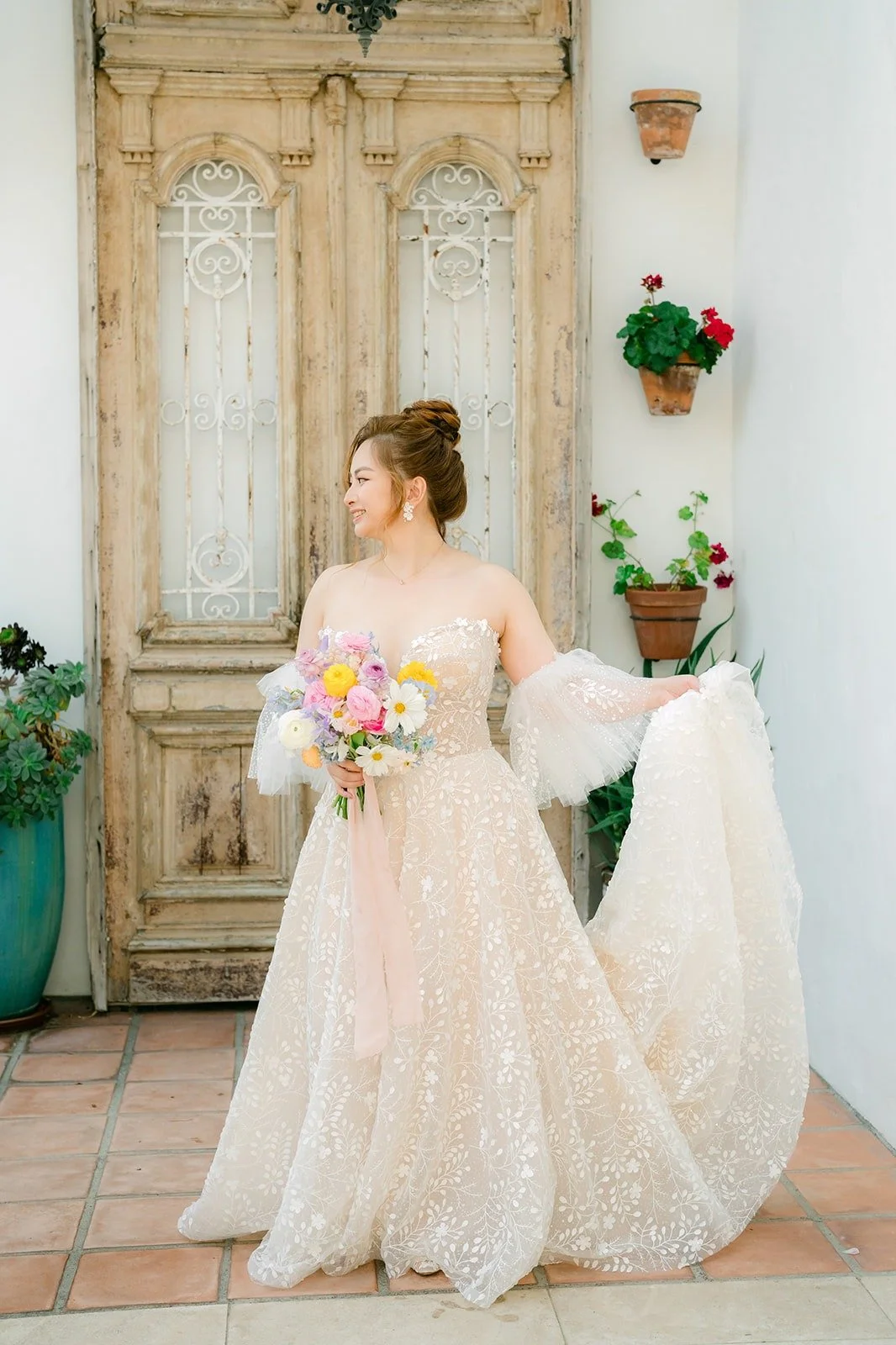 Joanna in front of the carved wooden door with her train spread out