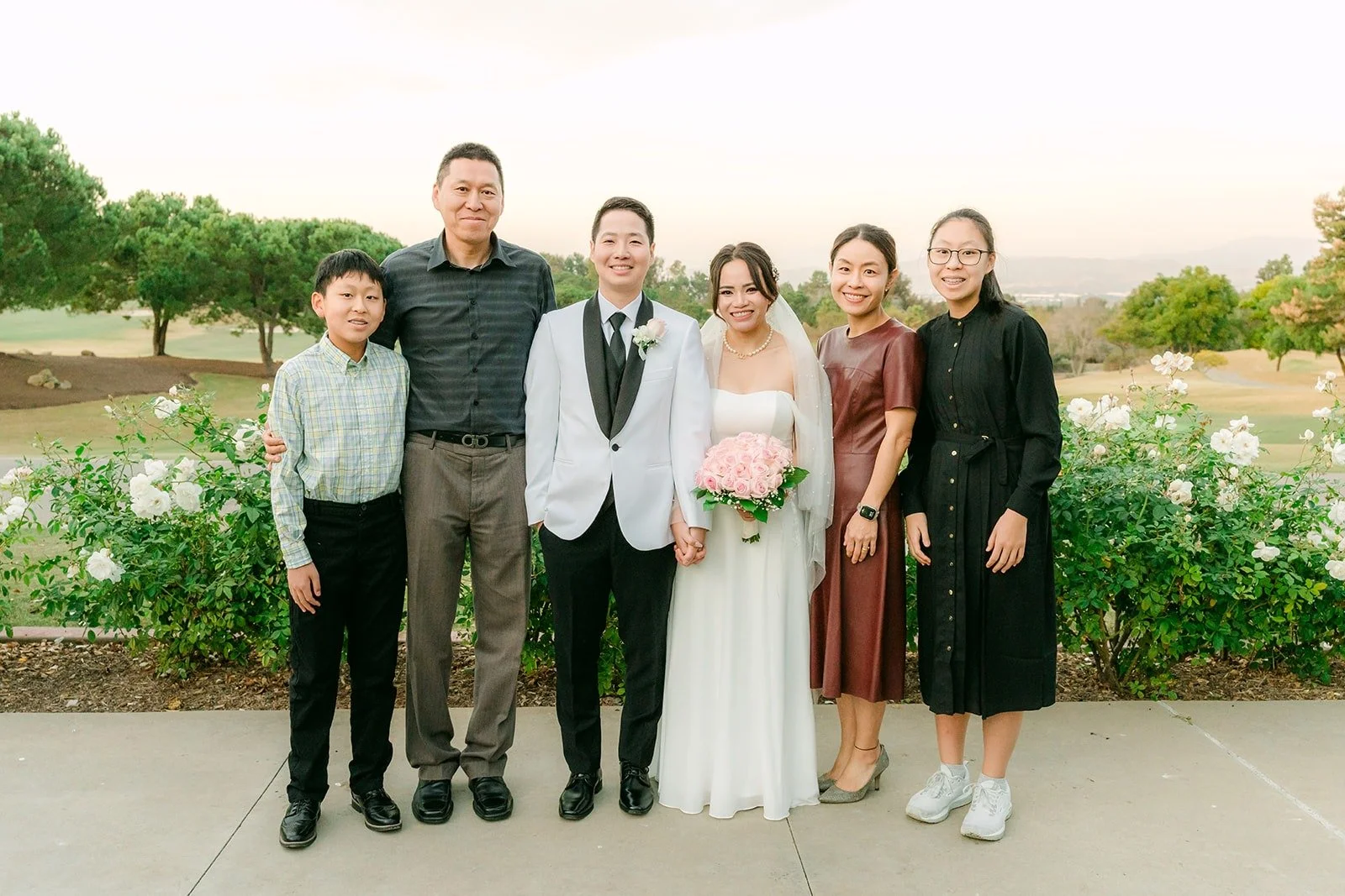 Ivy and Chungman with family above the golf course