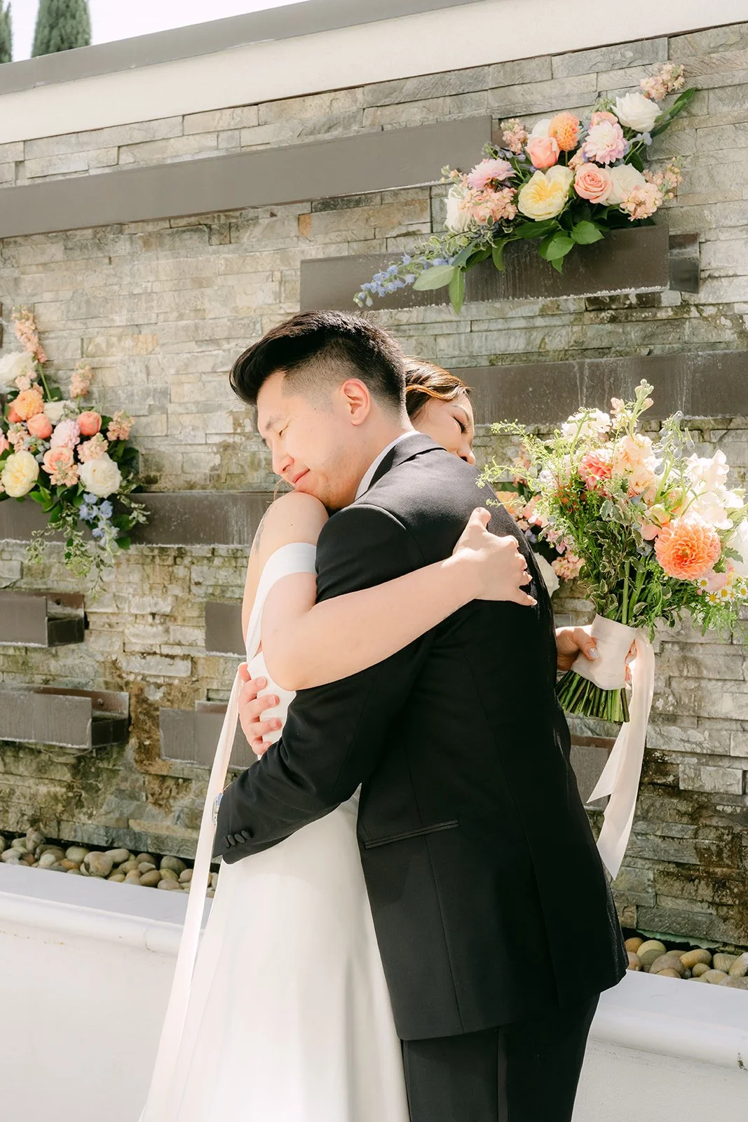 Amanda and San sharing a hug during their first look.