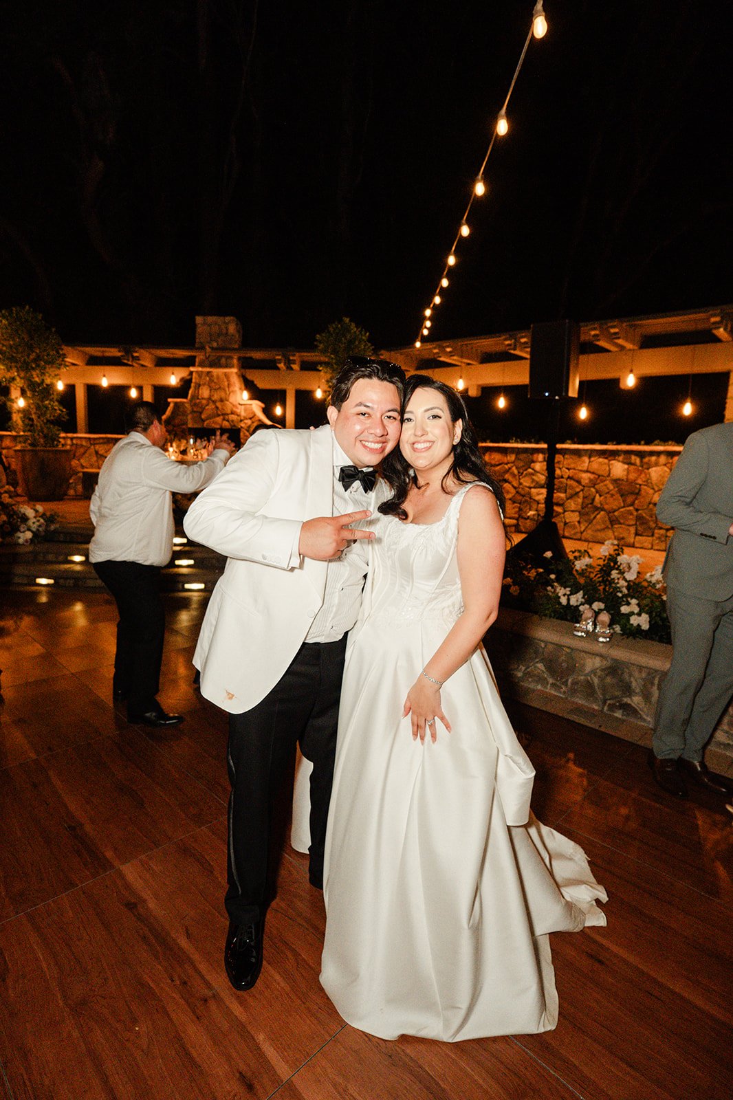 Couple posing on the dance floor at night