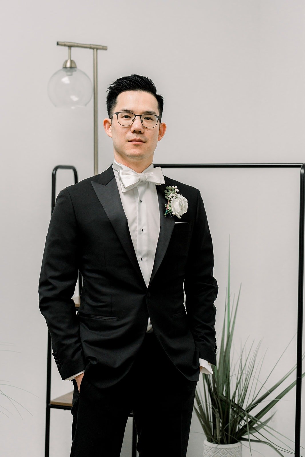 Alex in a black tuxedo and bow tie