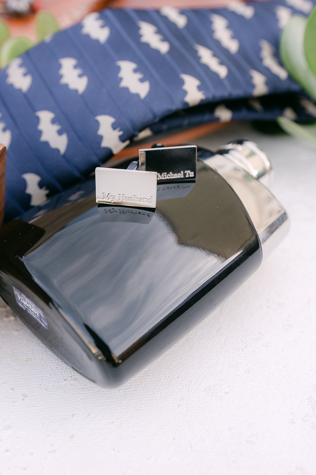 Michael's navy patterned tie and black leather wallet.