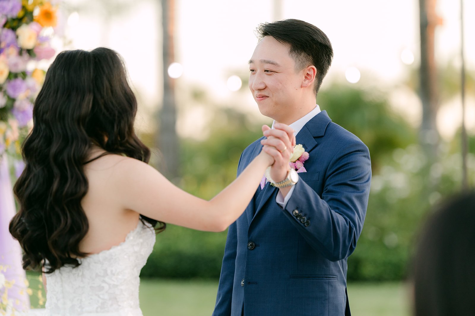 Vannie and Elijah's first dance in warm backlight.