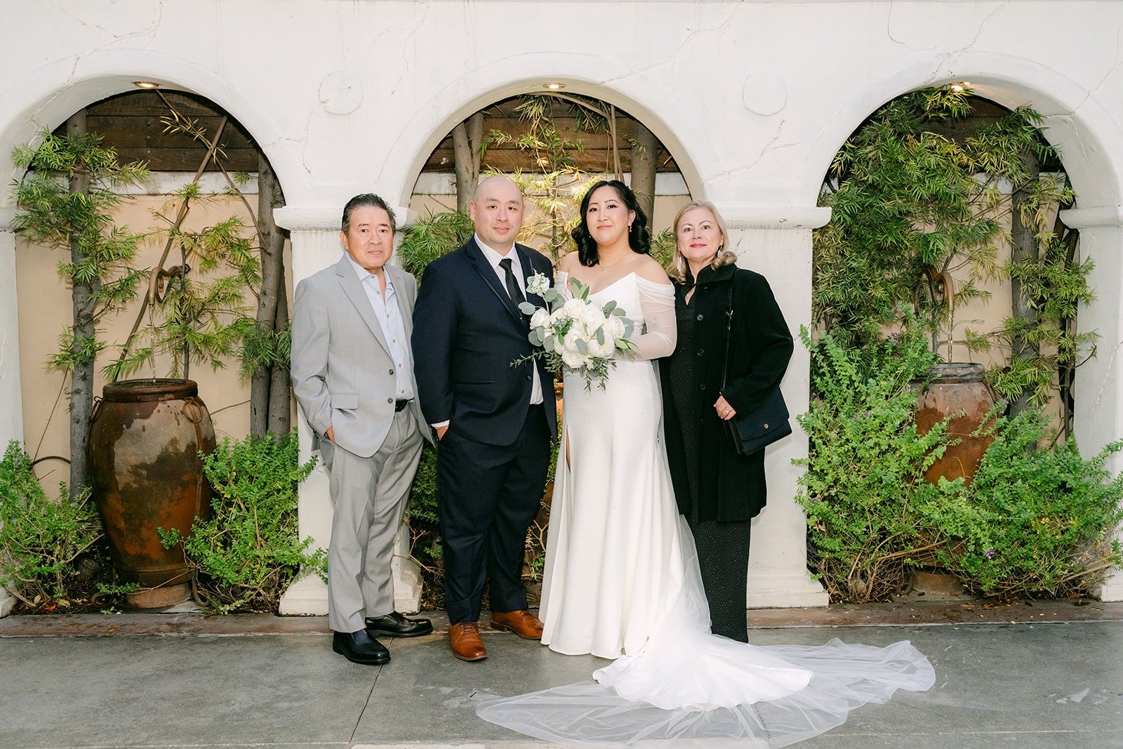 Vivian and Yao with family in the garden courtyard
