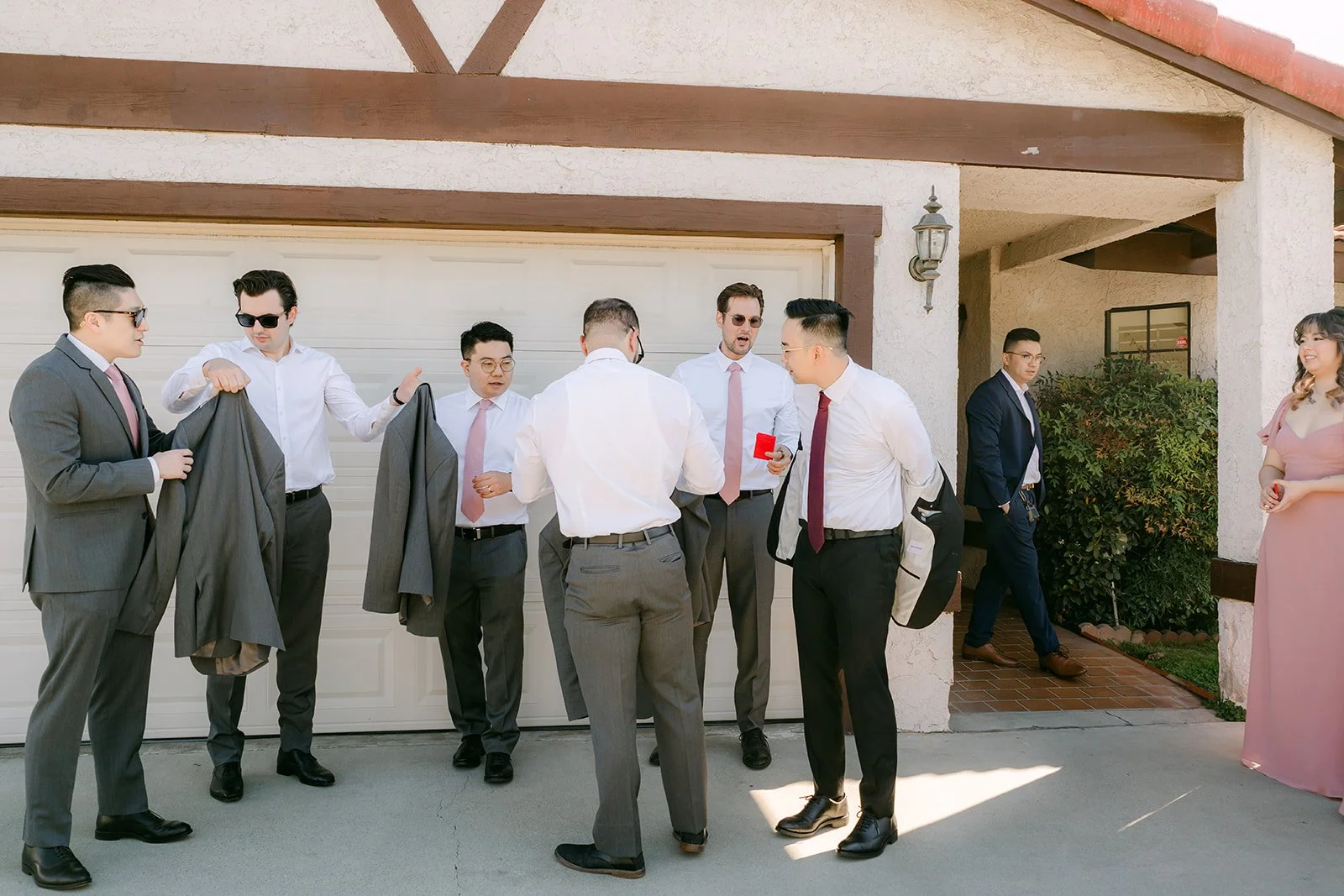 Groomsmen gathered at the garage during the door game.