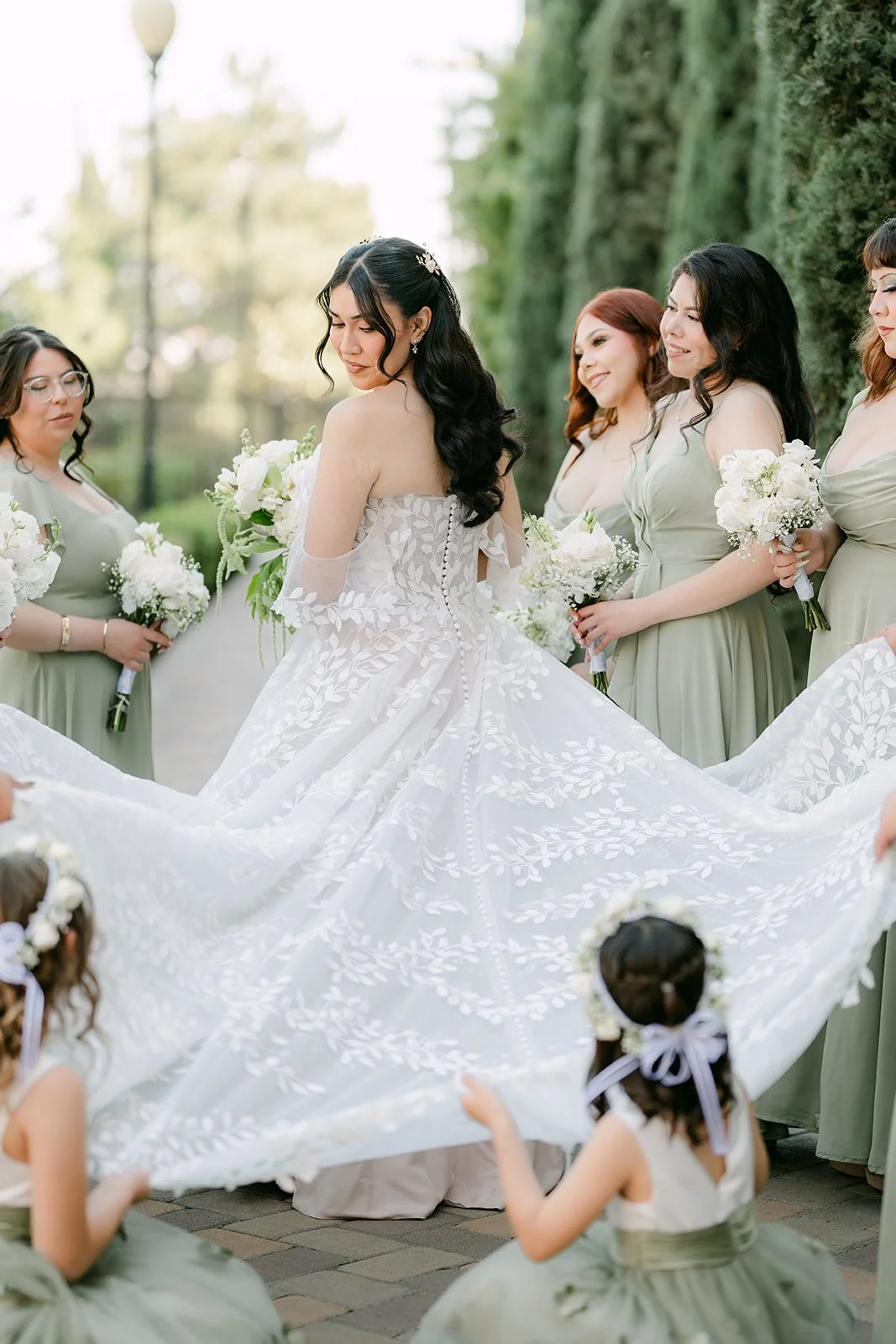 Fernanda spinning in her gown as her bridesmaids cheer.