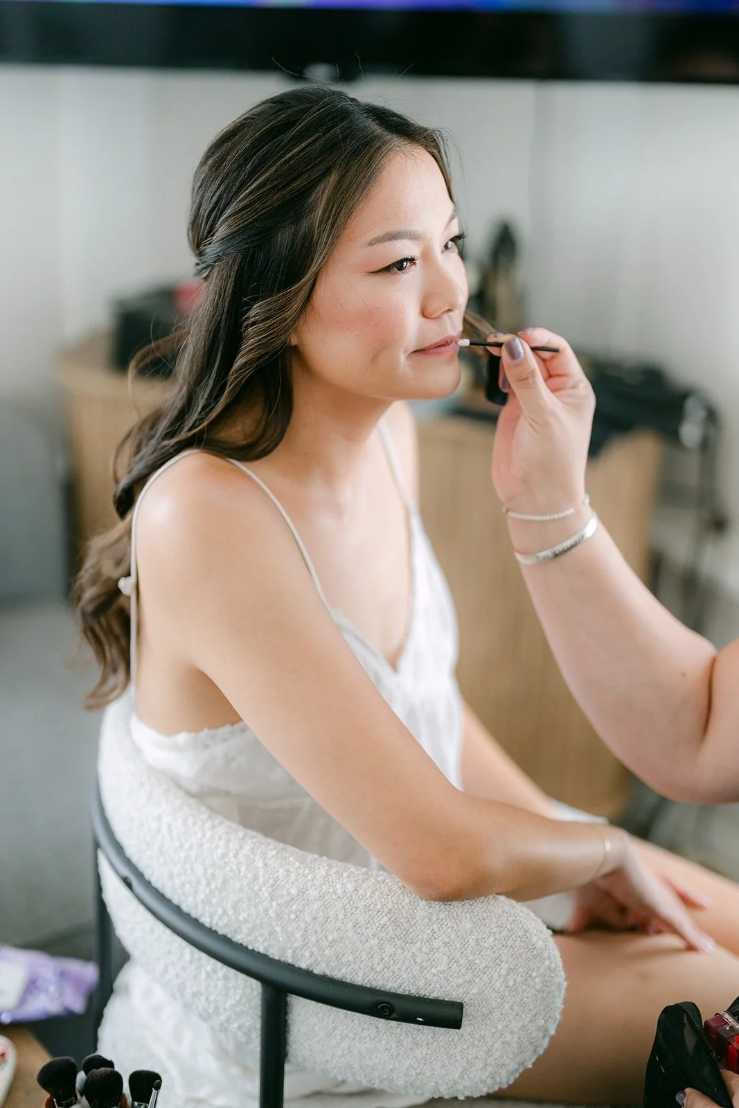 Jadee having her makeup done on the morning of her wedding at The Harper