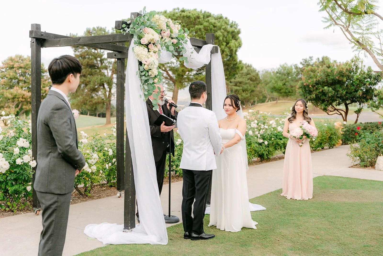 Wide view of the ceremony arch overlooking the golf course