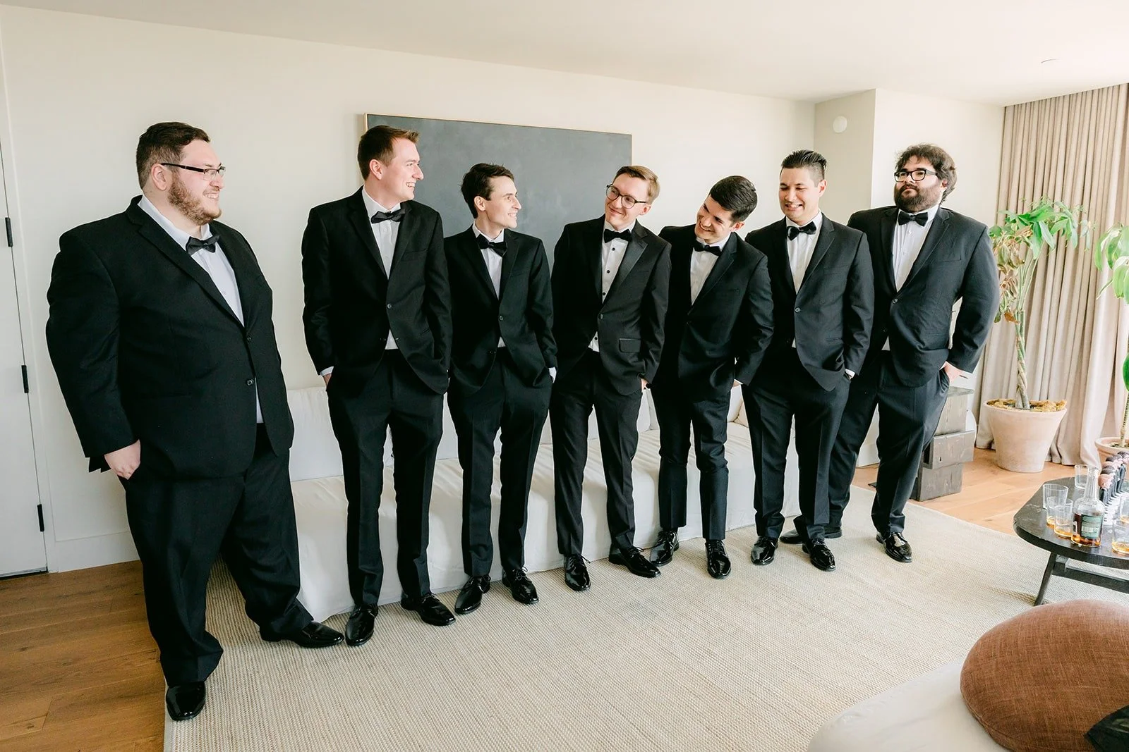 Nik and his groomsmen lined up in black tuxedos