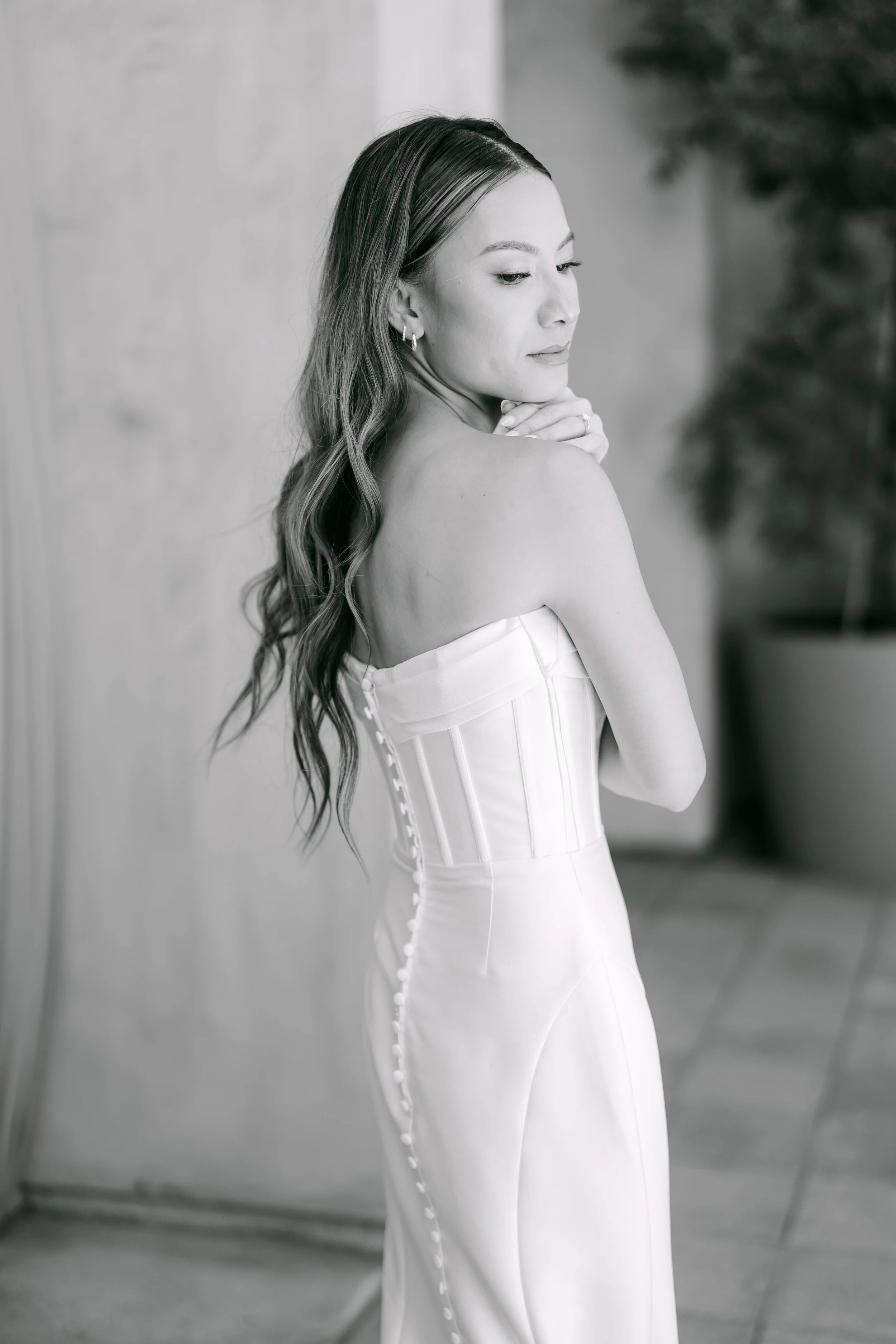 Black and white bridal portrait of Kieu showing the buttons down the back of her gown