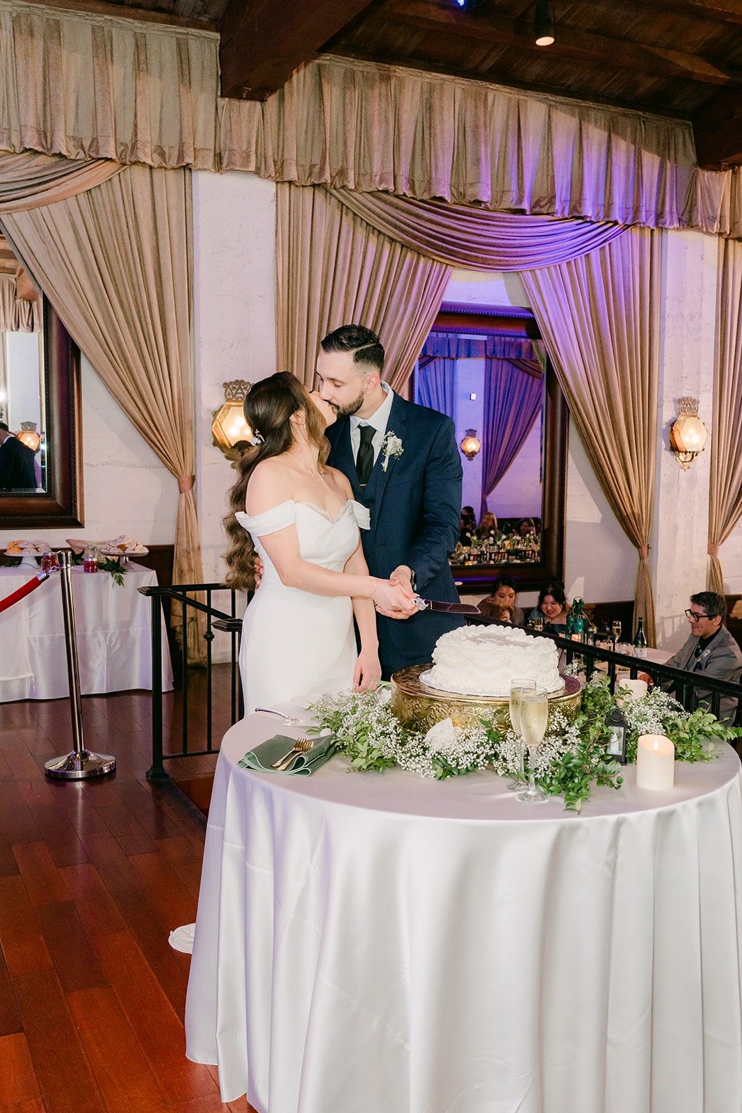 Mariana and Danny cutting their wedding cake