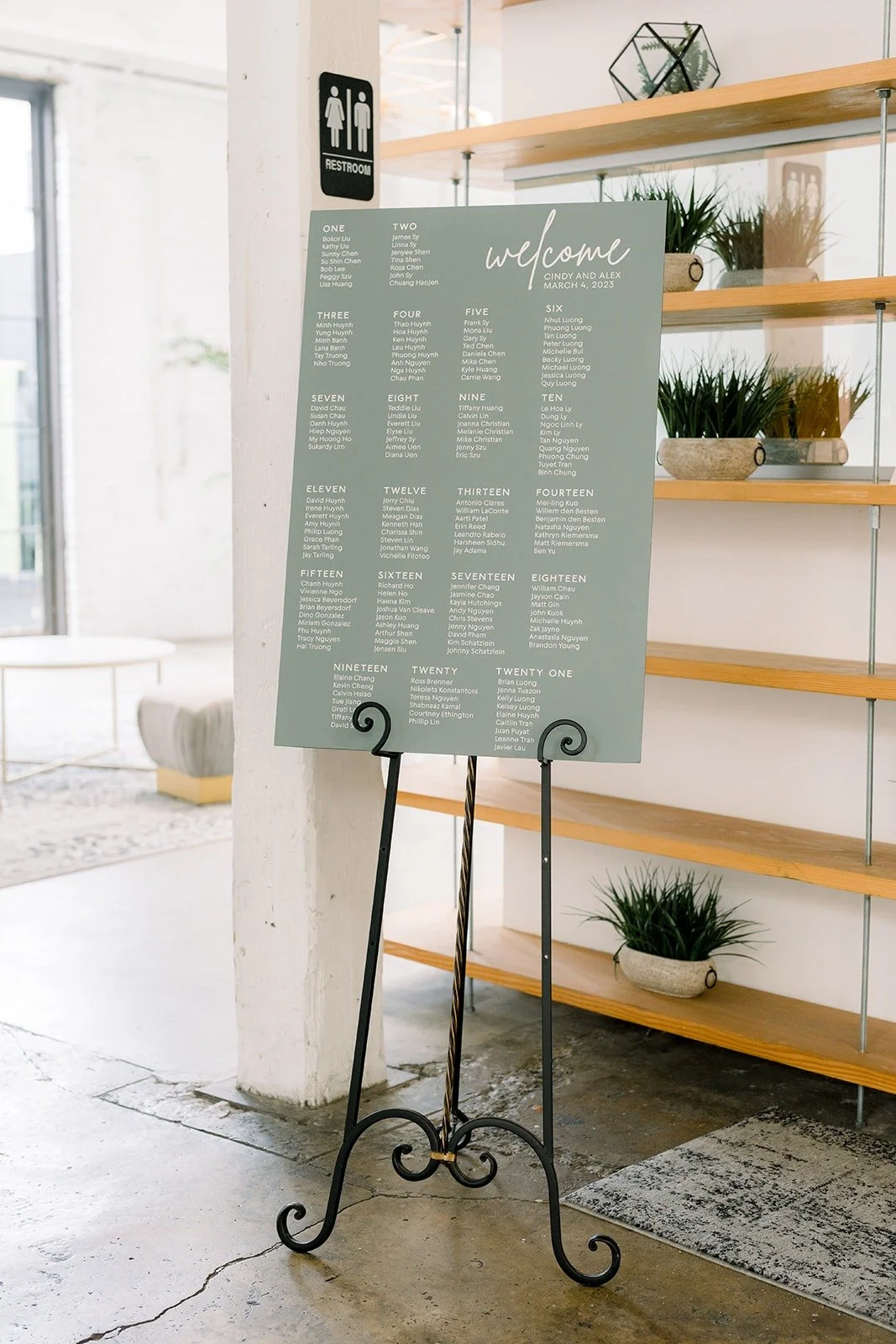 Sage green seating chart on an easel