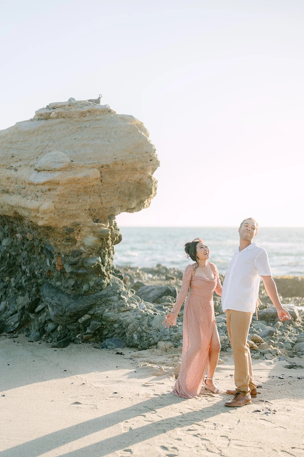 Amy and Michael walking past the sandstone rock.