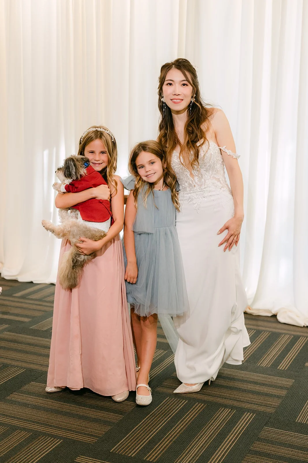 Christie posing with two young guests at the reception.