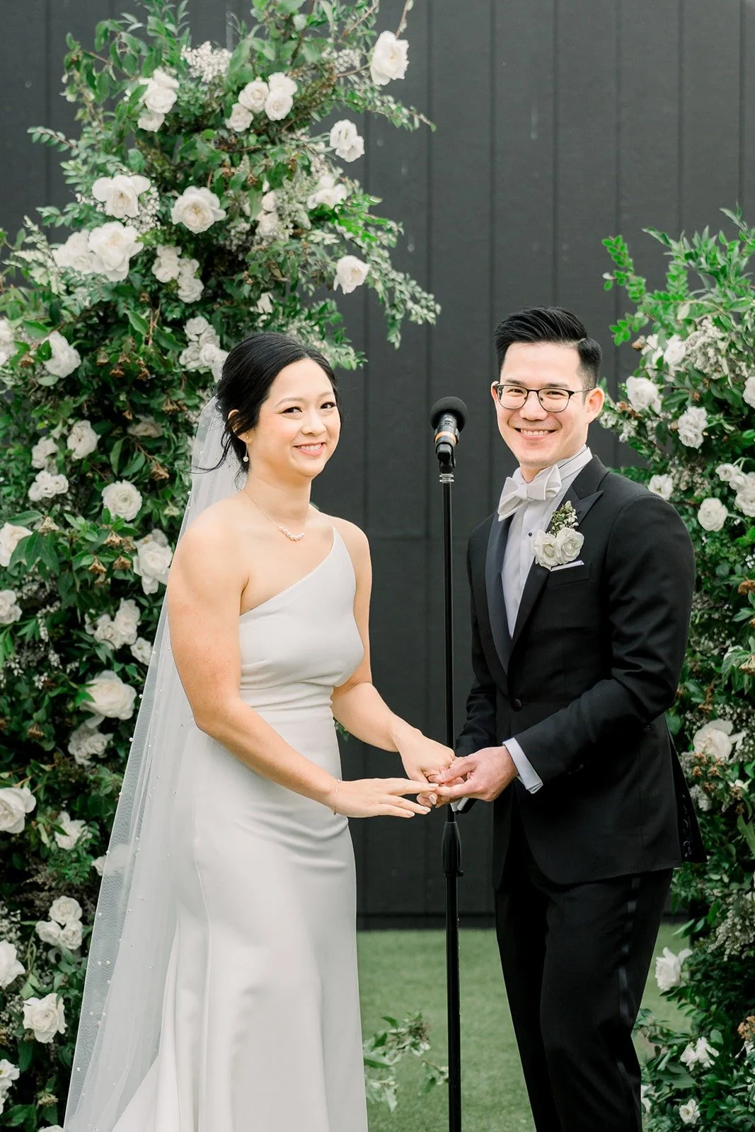 Cindy and Alex smile at each other during the vows