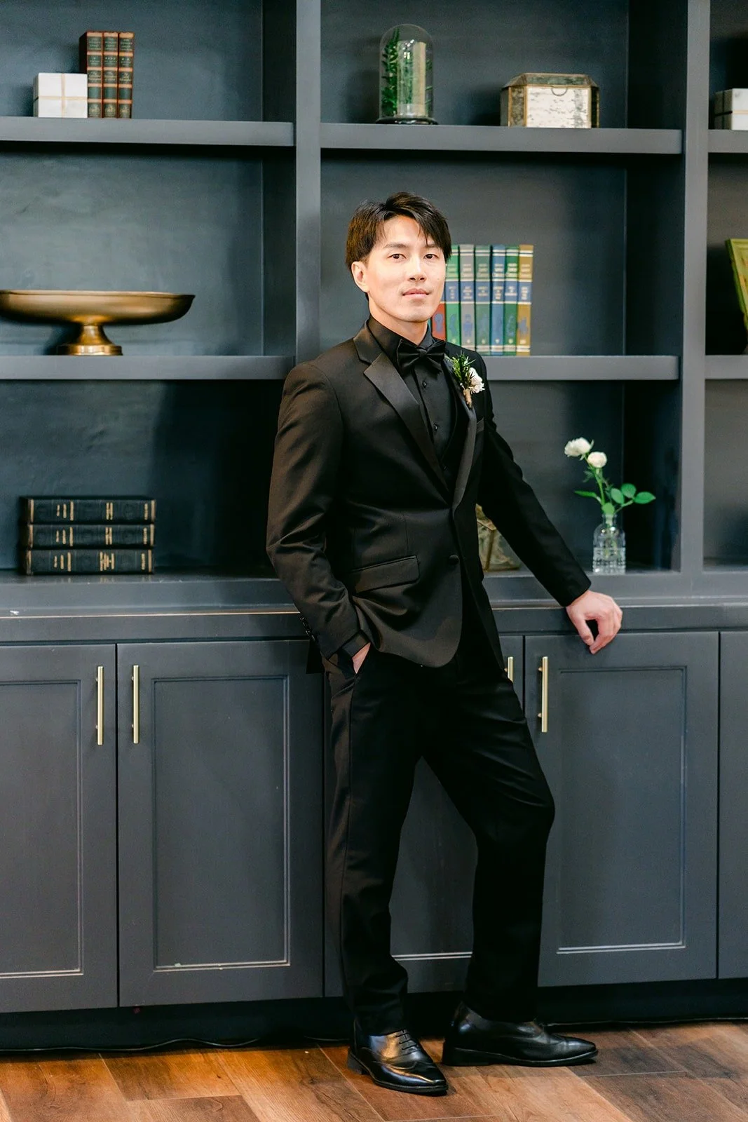 Fong in a black tuxedo in the groom's suite