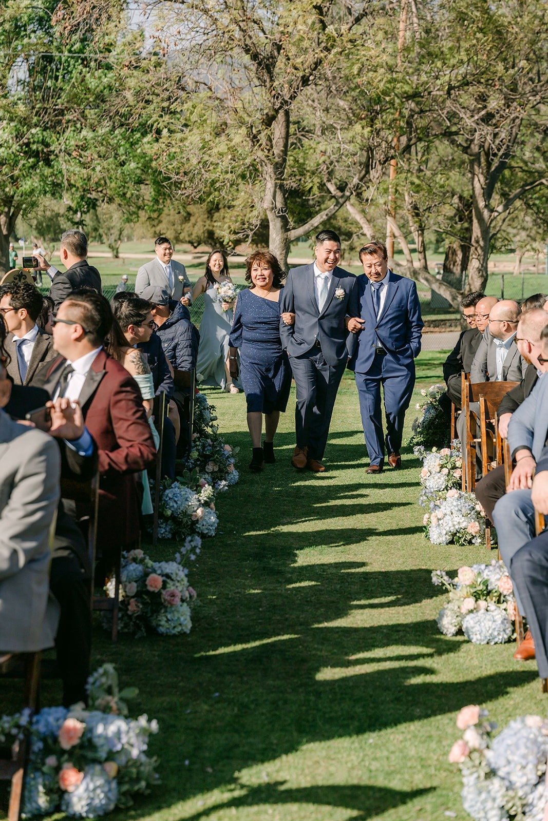 Guests standing on both sides of the aisle on the 15th hole