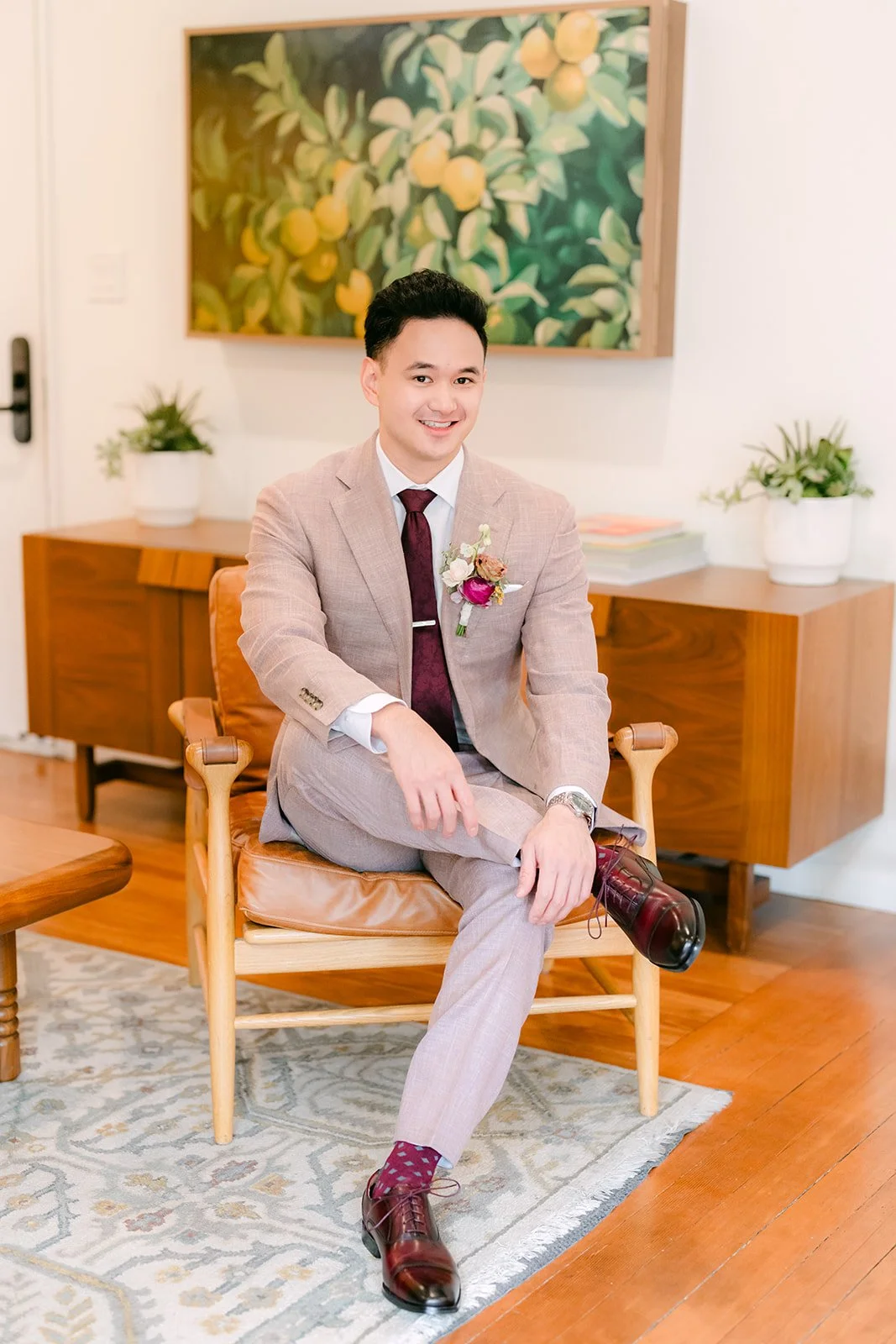 Michael seated in a wood armchair in the living room at The Richland.