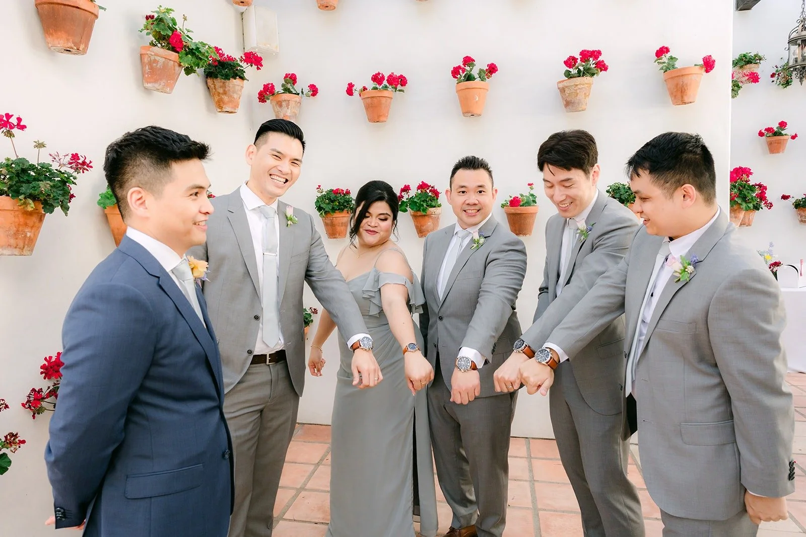 Jerrick and his party lined up along the geranium wall