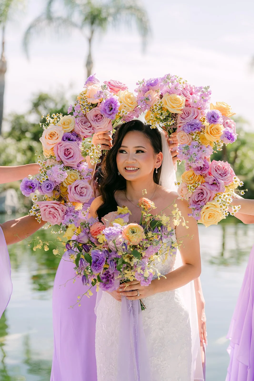 Vannie framed by a ring of bridesmaid bouquets.