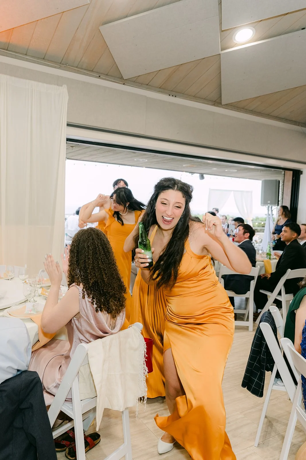 A bridesmaid dancing into the reception