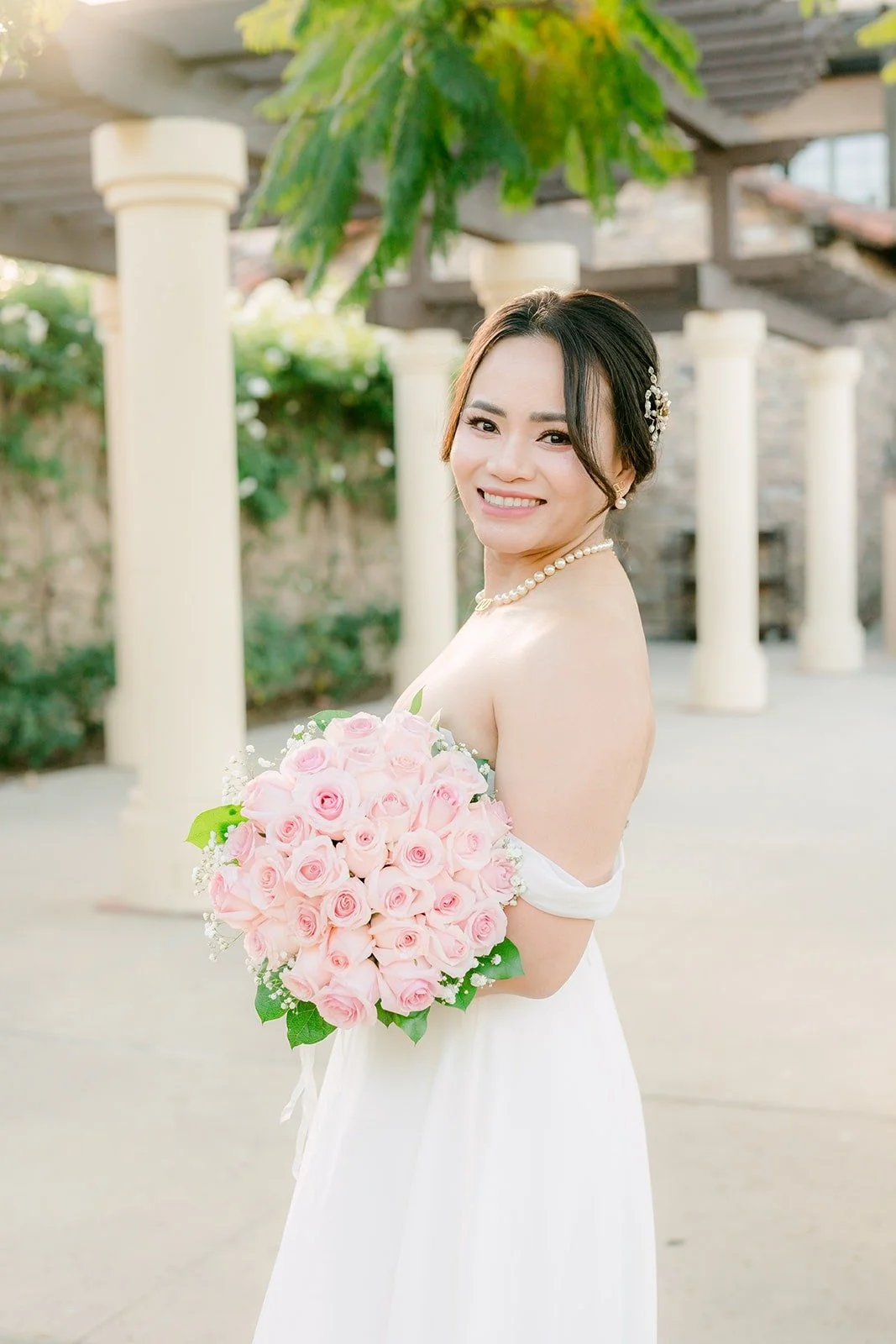Ivy looking over her shoulder with her bouquet