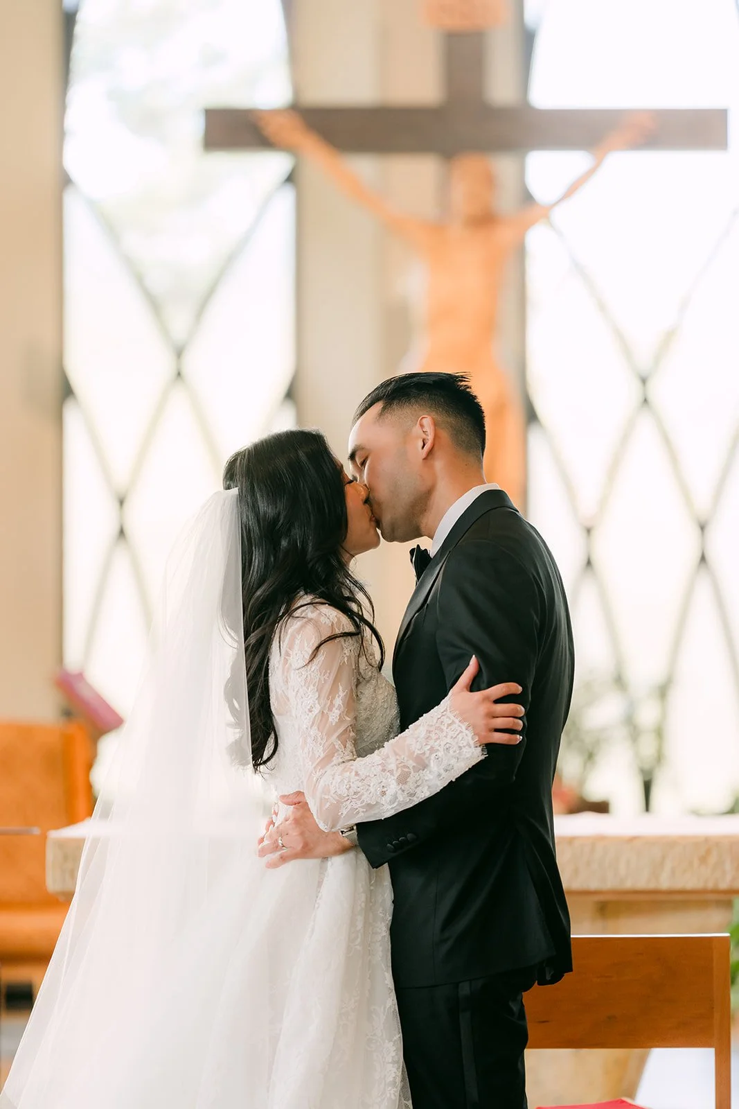 Kim and Vincent's first kiss at the altar of St. John Fisher Church