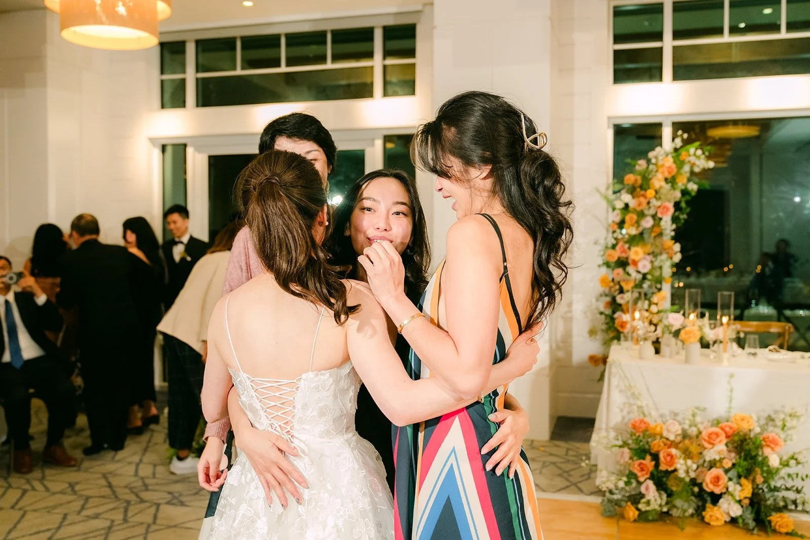 A guest celebrating after catching the bouquet, photographed by One and Only Production