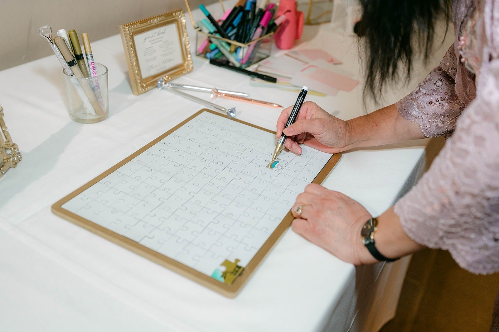 A guest signing the guest book frame