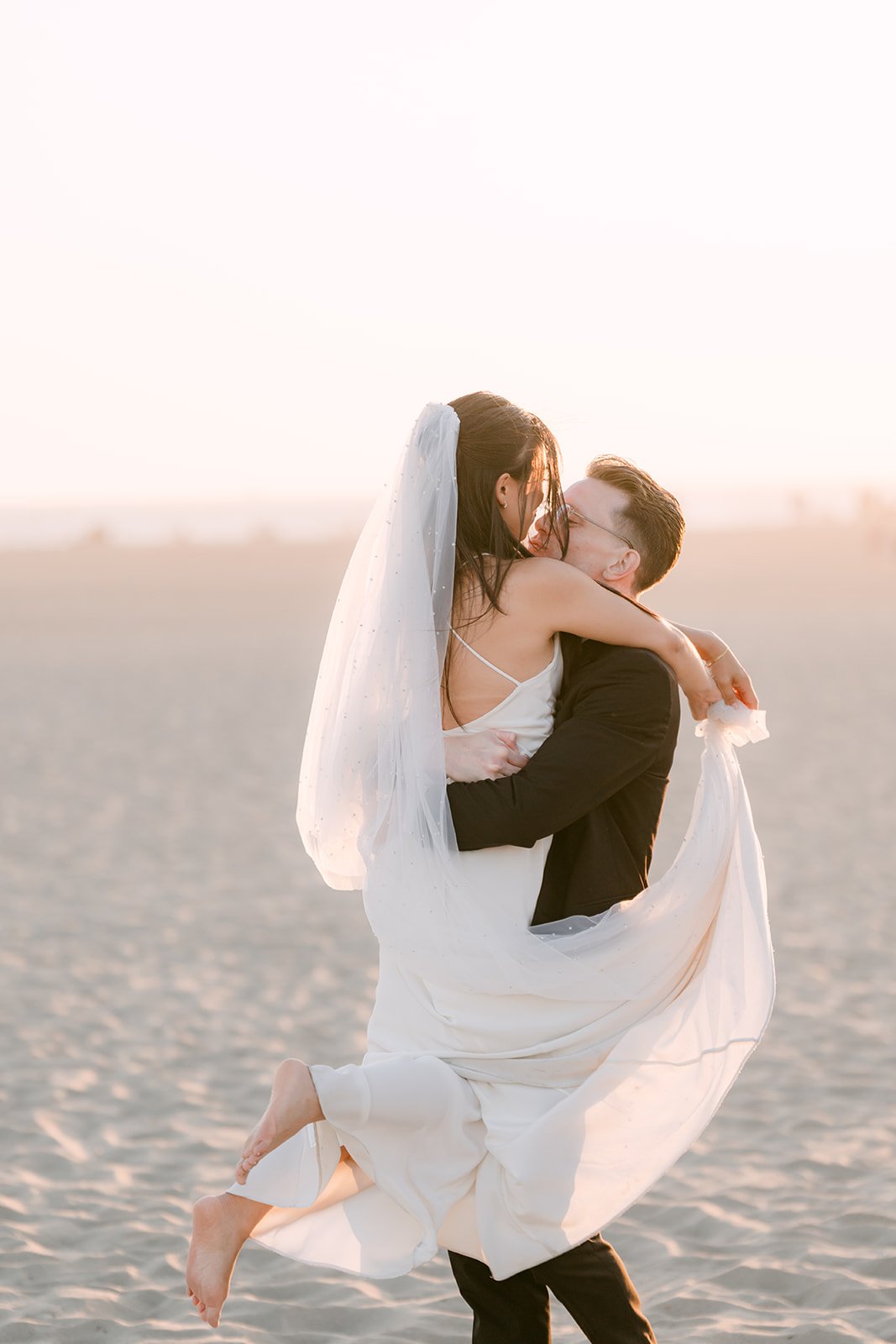 Matthew lifting Justine on the beach