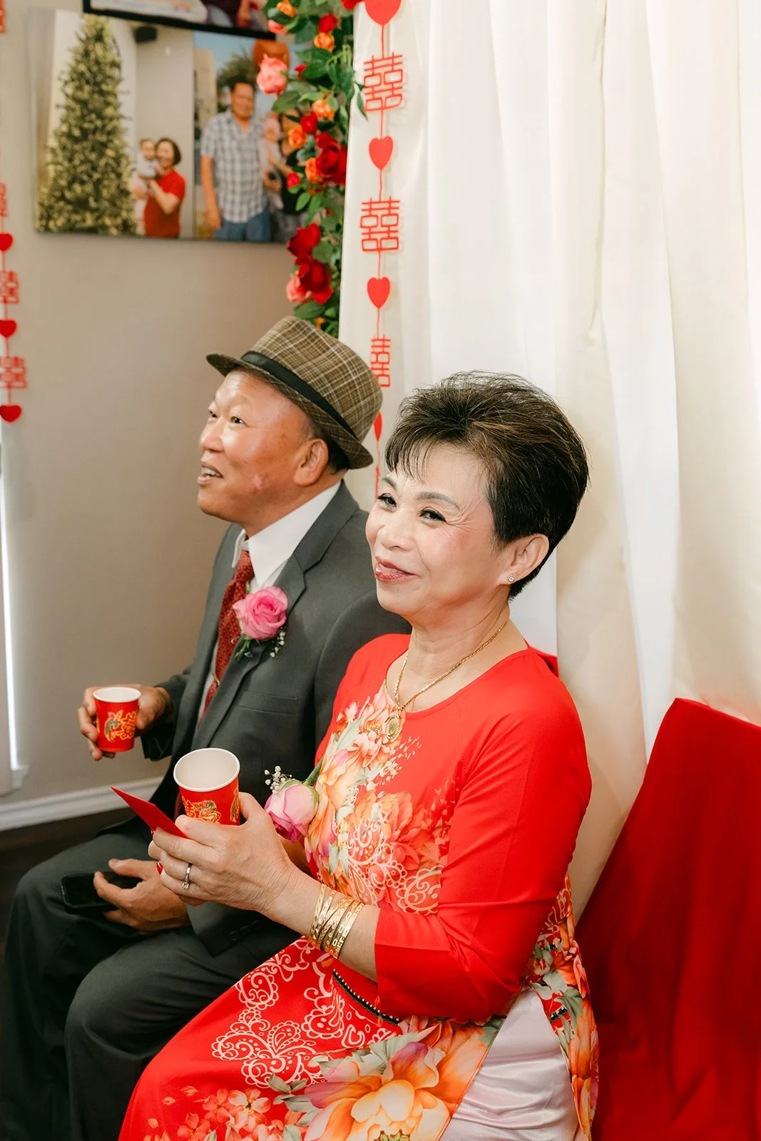 Older relatives smiling with their tea cups.